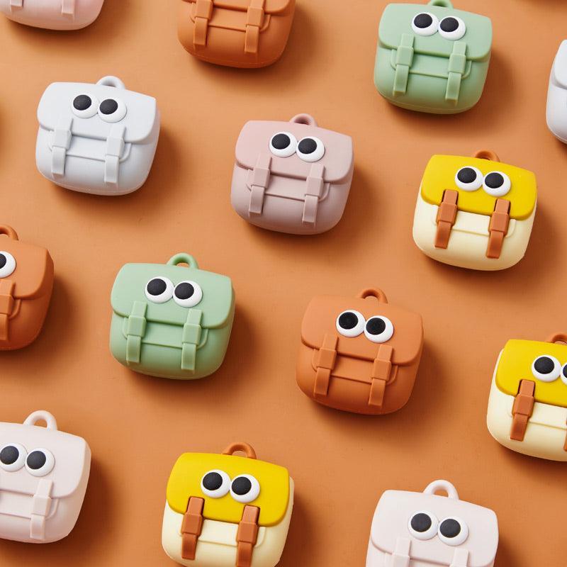 Cute mini backpack charms in pastel colors with googly eyes, perfect for bags and accessories