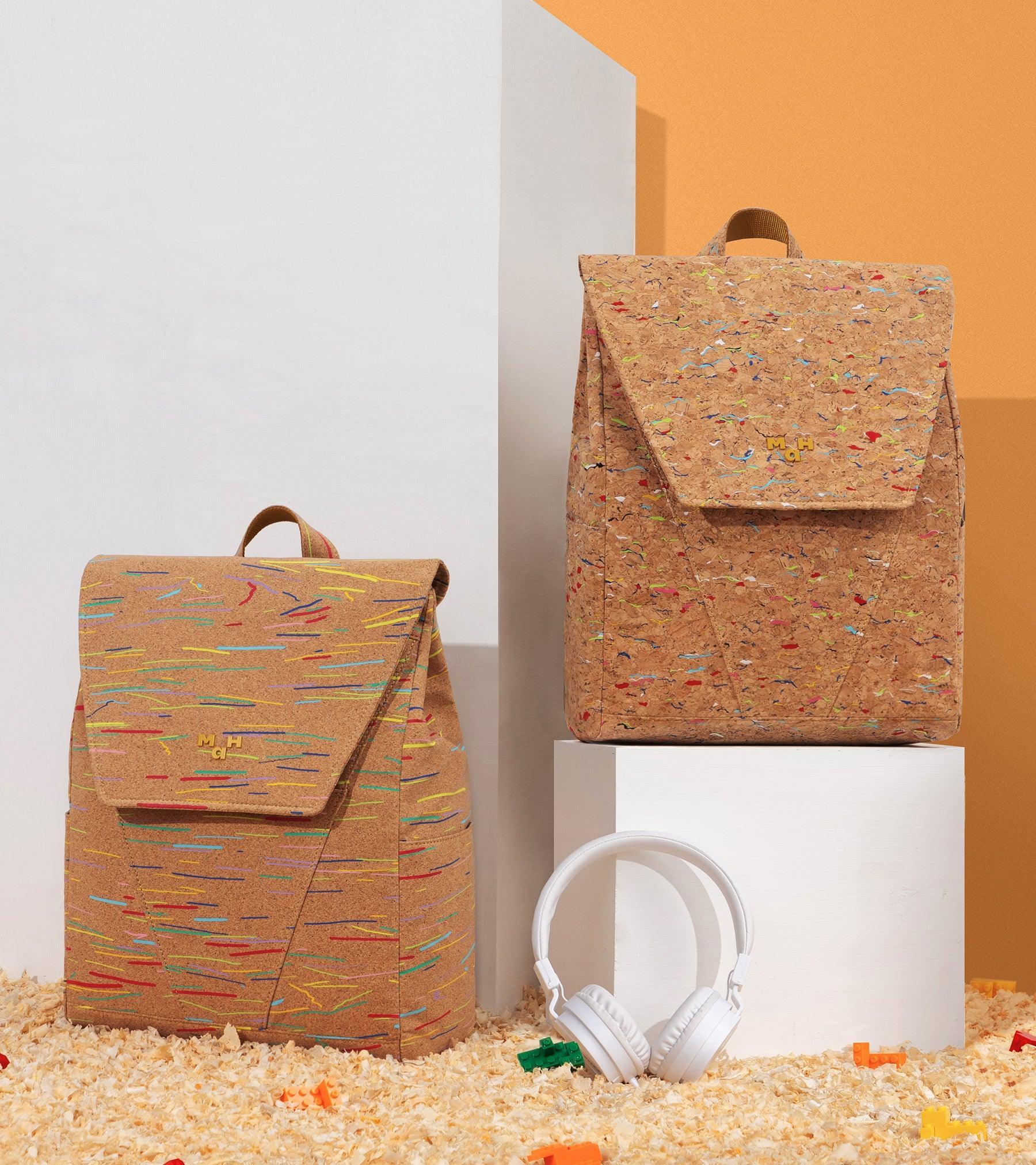 Colorful confetti-pattern cork backpacks with white headphones and LEGO bricks on wood shavings