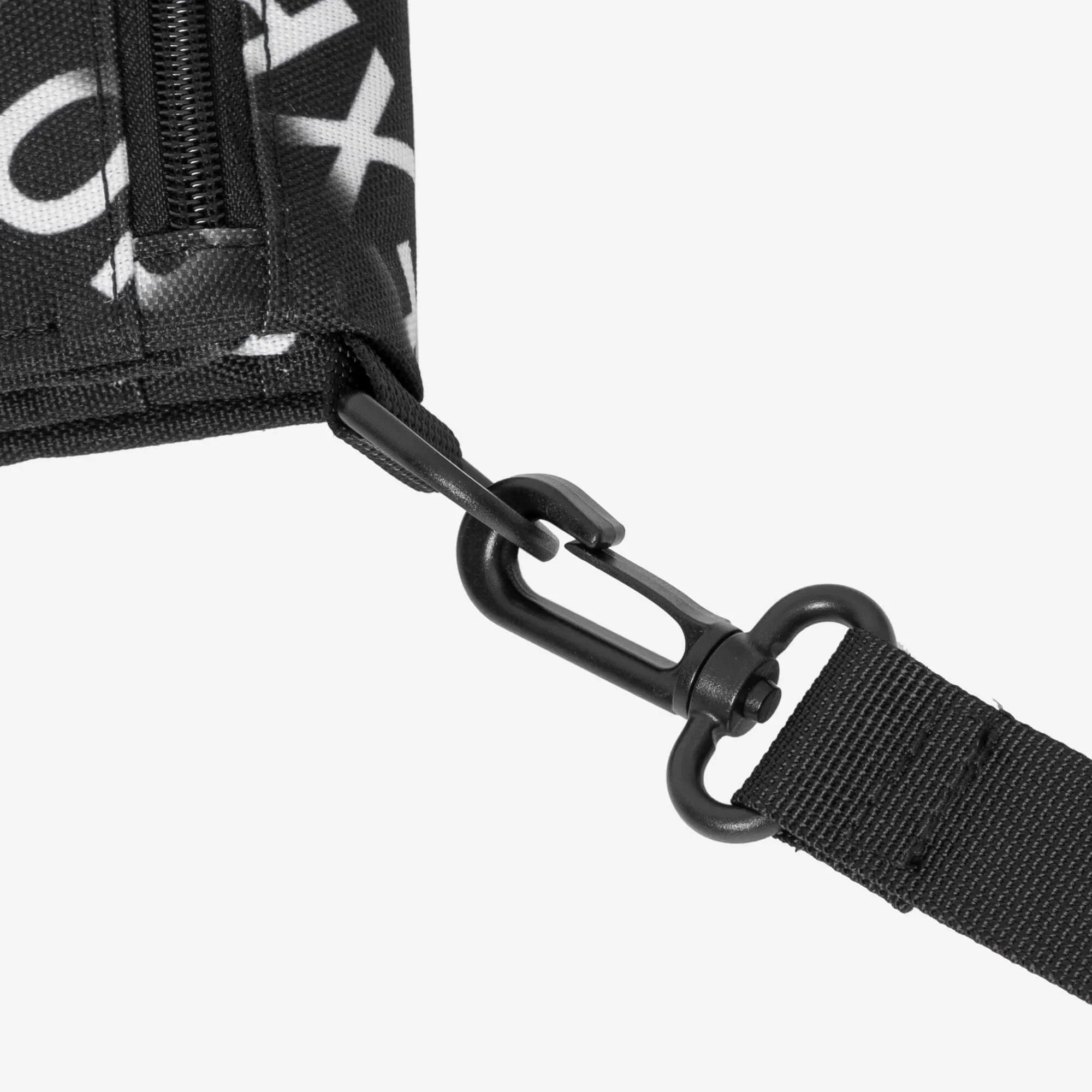 Black and white patterned bag with zipper and adjustable strap clip detail