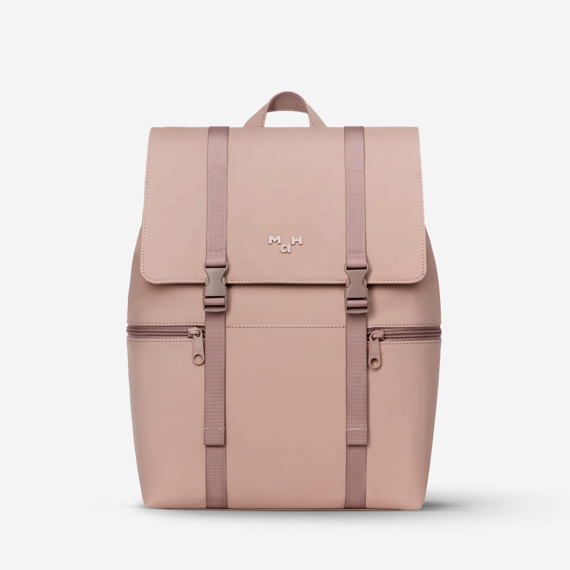 Dusty pink minimalist backpack with front flap, dual straps, and zippered pockets for daily use