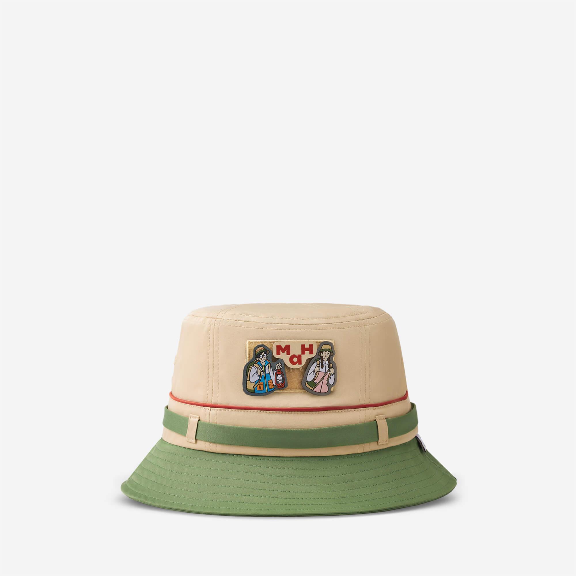 Beige and green bucket hat with colorful explorer patch and adjustable strap, ideal for outdoor adventures.