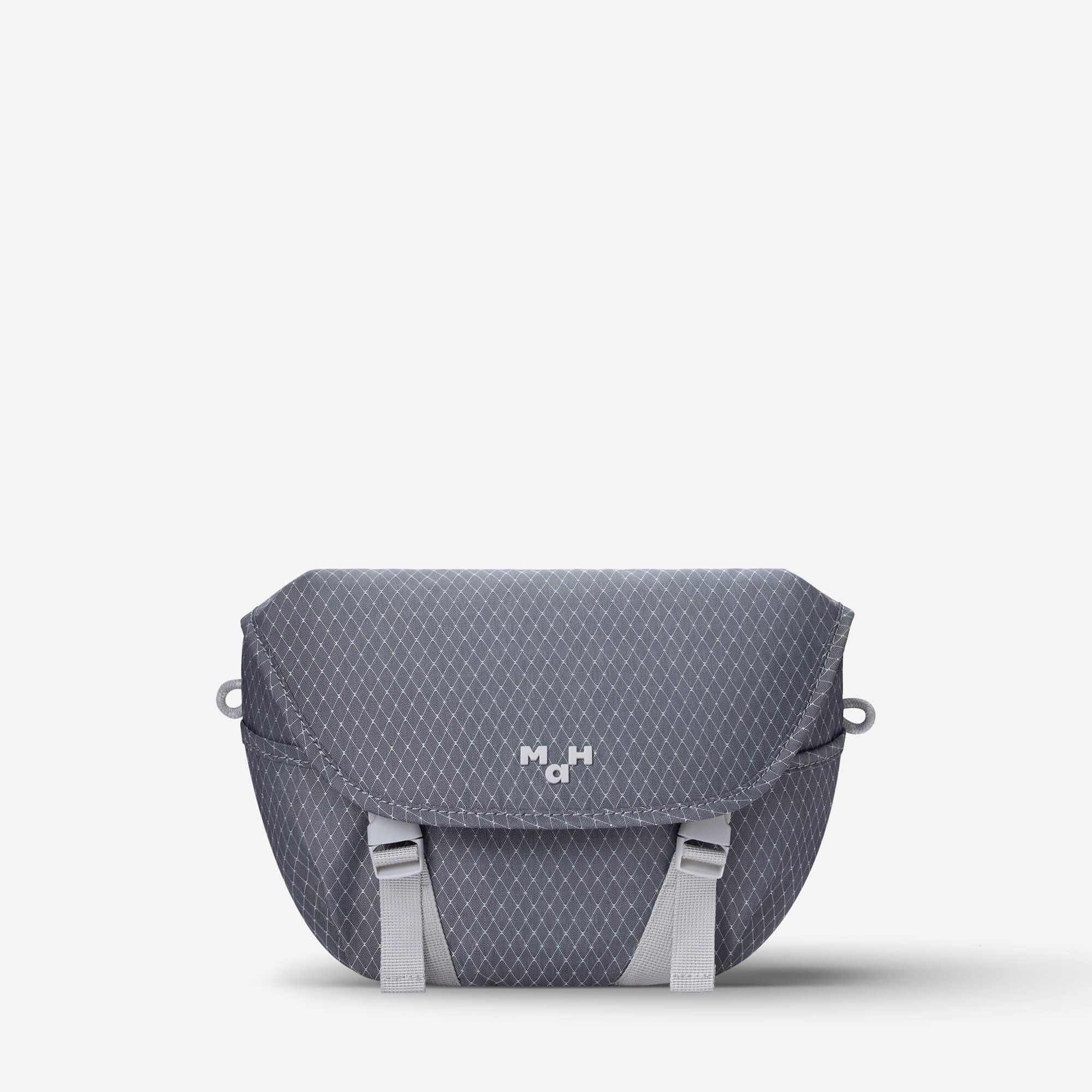 Gray patterned saddle bag with white logo and straps, minimalist design for everyday use