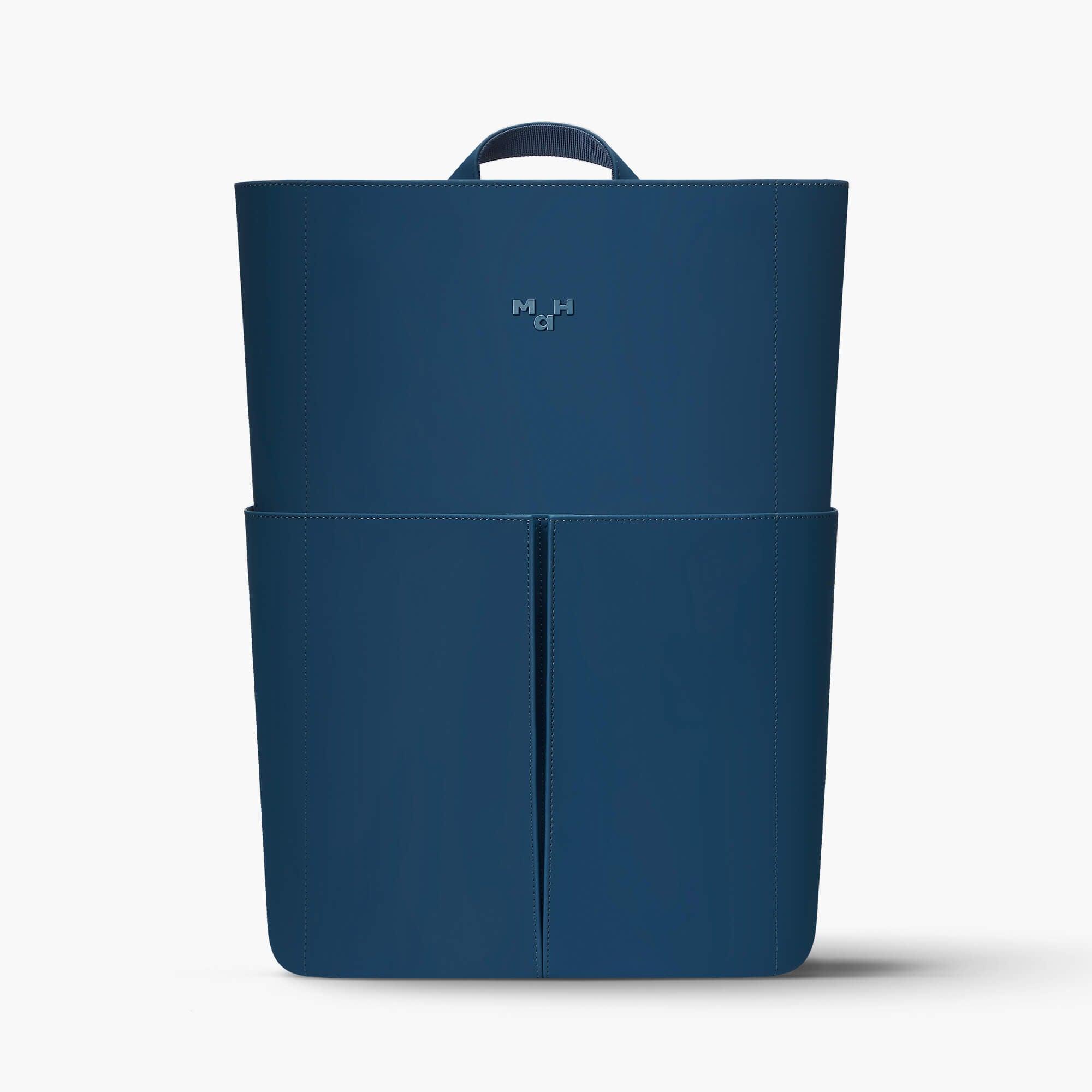 Navy blue minimalist backpack with front pocket and top handle, sleek design for daily use