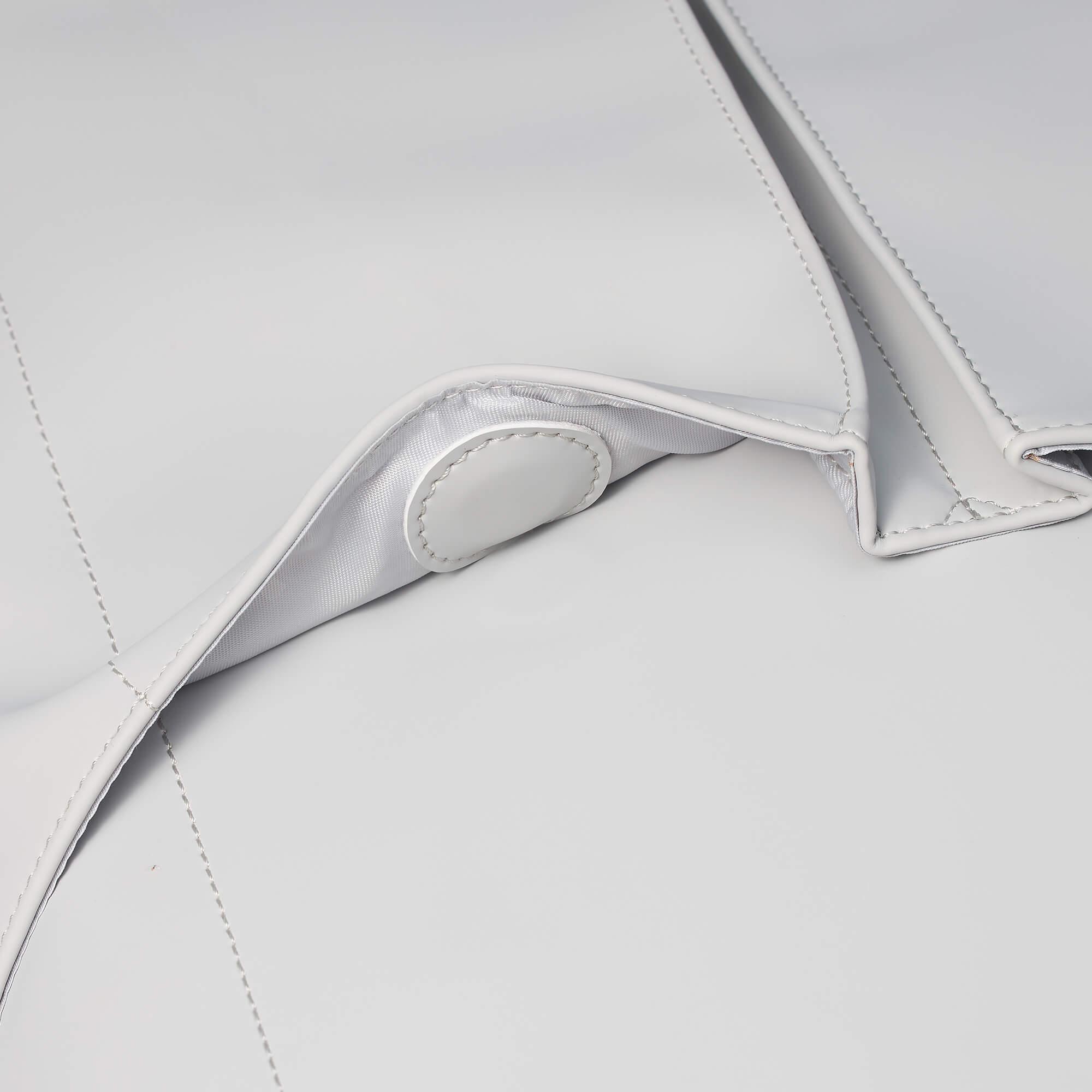 White minimalist bag with clean stitching and satin lining detail