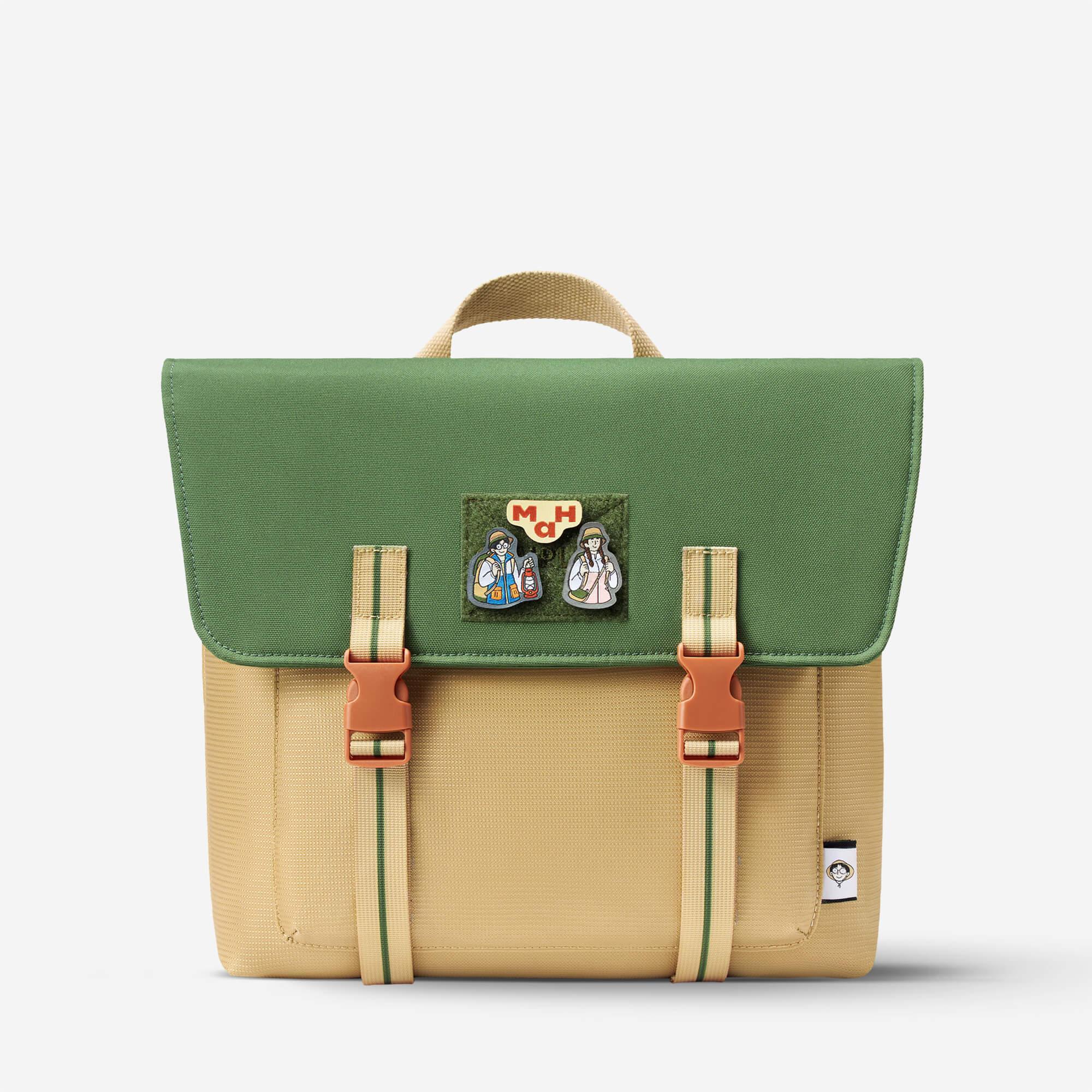 Green and beige satchel bag with character patches and buckle straps, ideal for school or daily use.