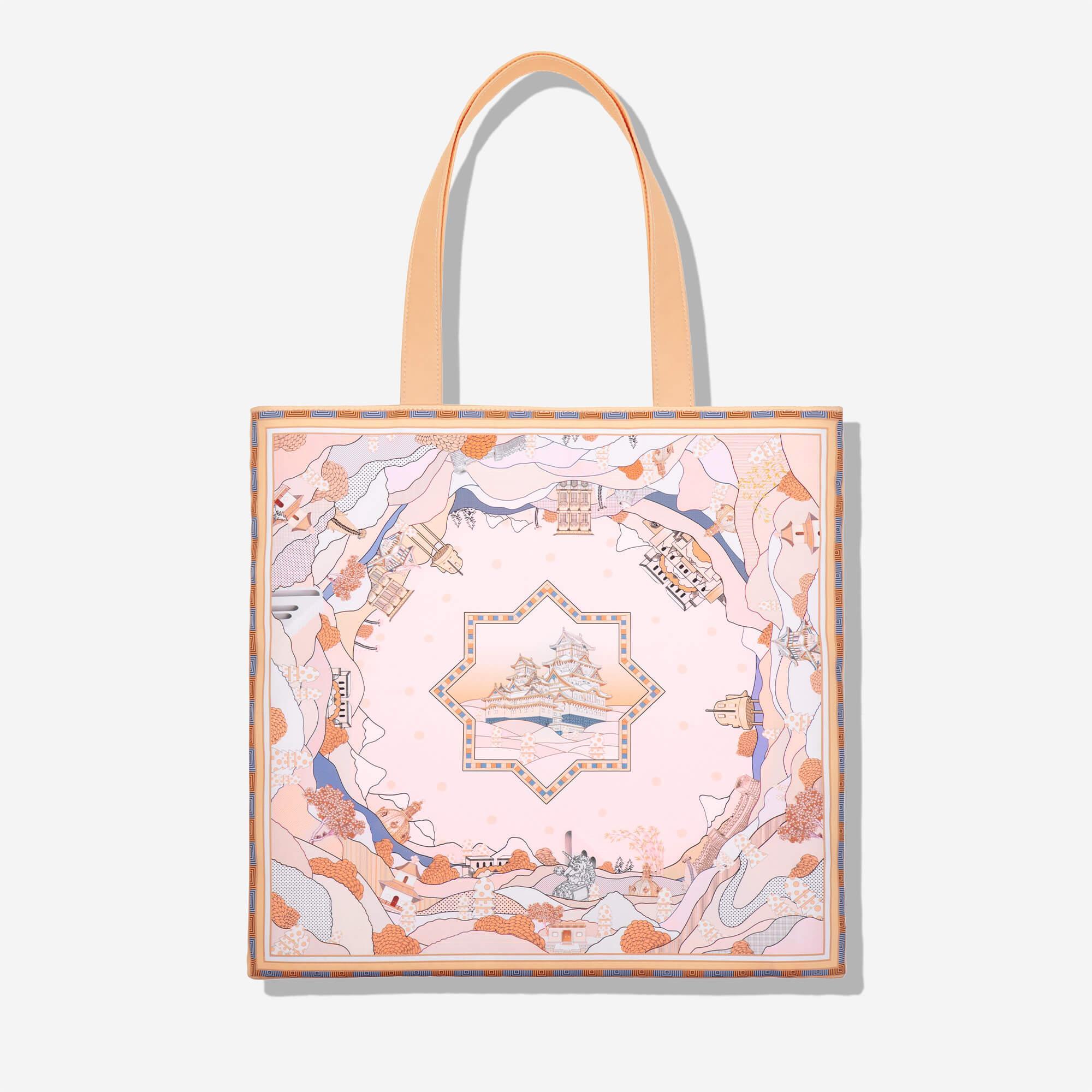 Stylish tote bag with Japanese castle print, pastel landscape design, and peach handles for everyday use