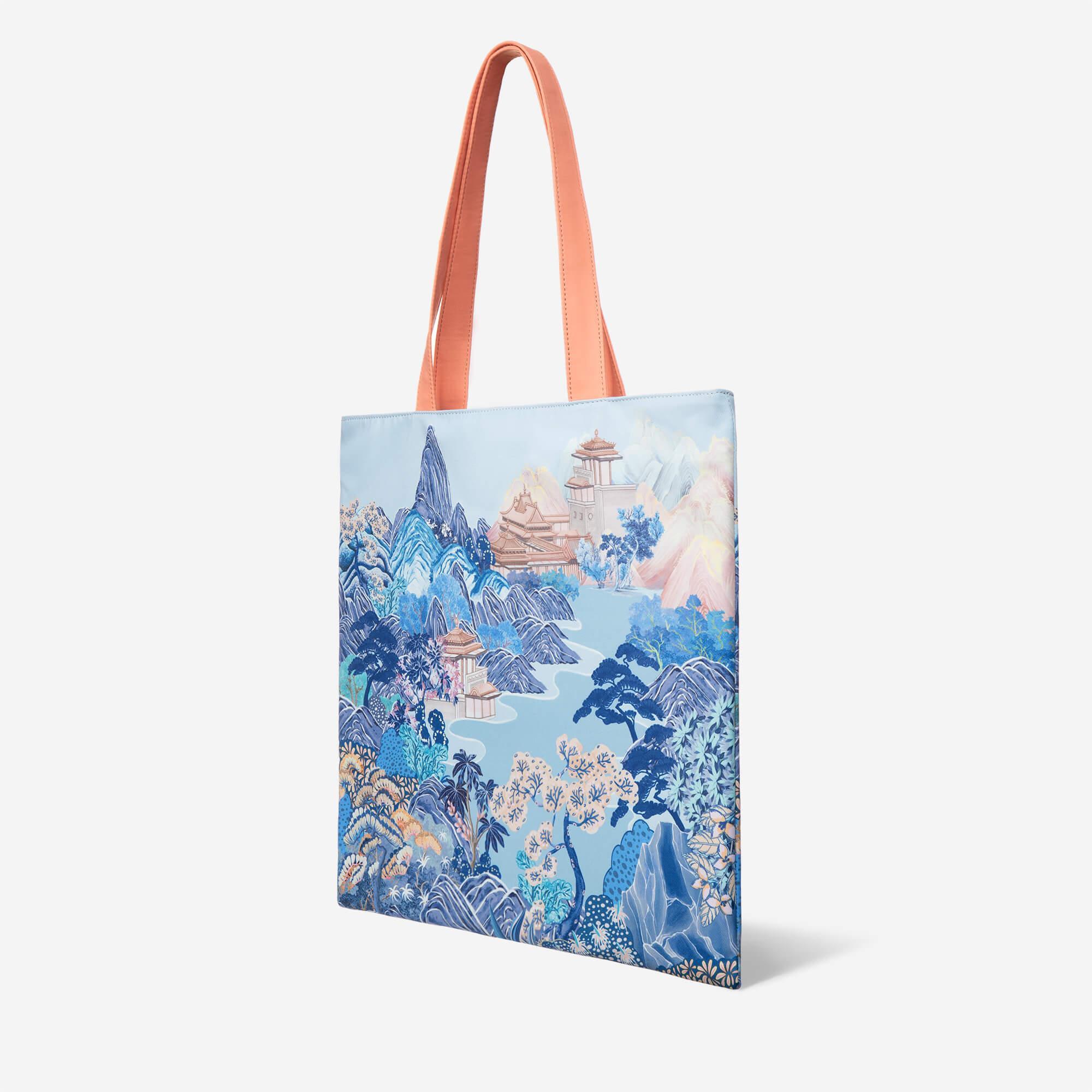 Tote bag with blue mountain landscape print and peach handles, stylish everyday carry
