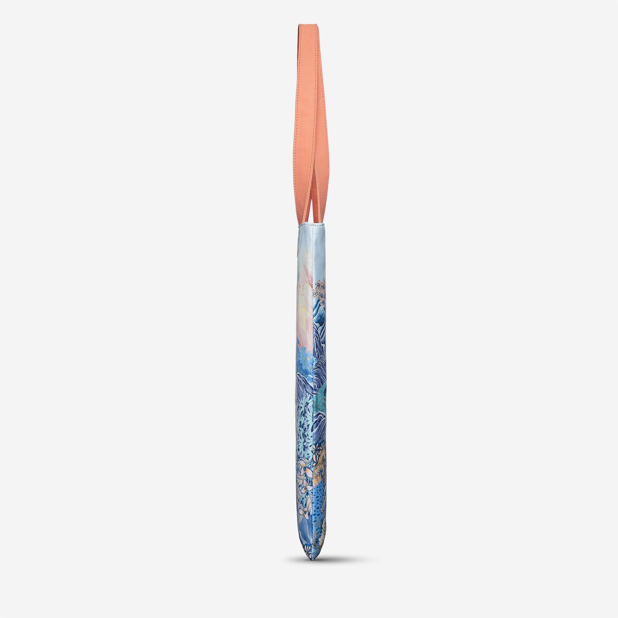 Blue floral patterned laptop sleeve with peach strap, stylish accessory for everyday use