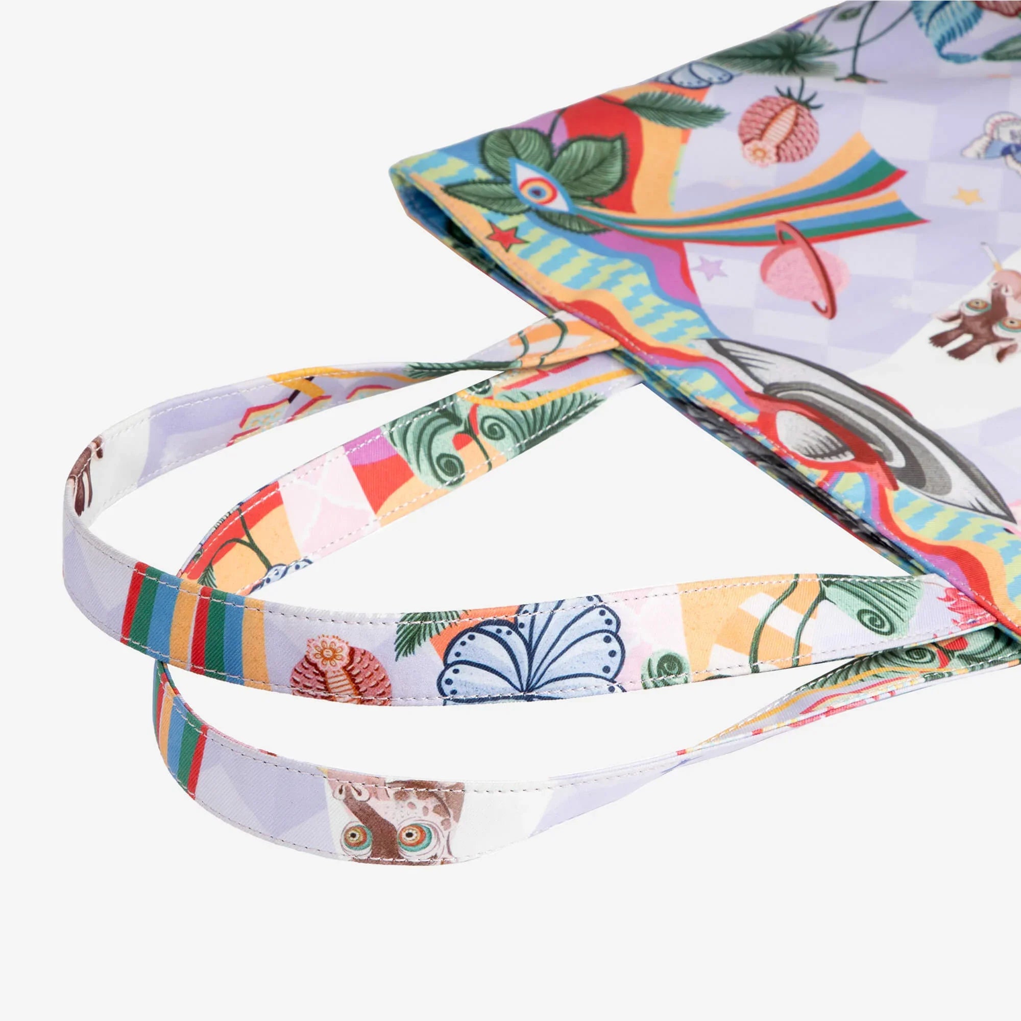 Colorful patterned tote bag with whimsical art, tropical leaves, and playful designs for everyday use.