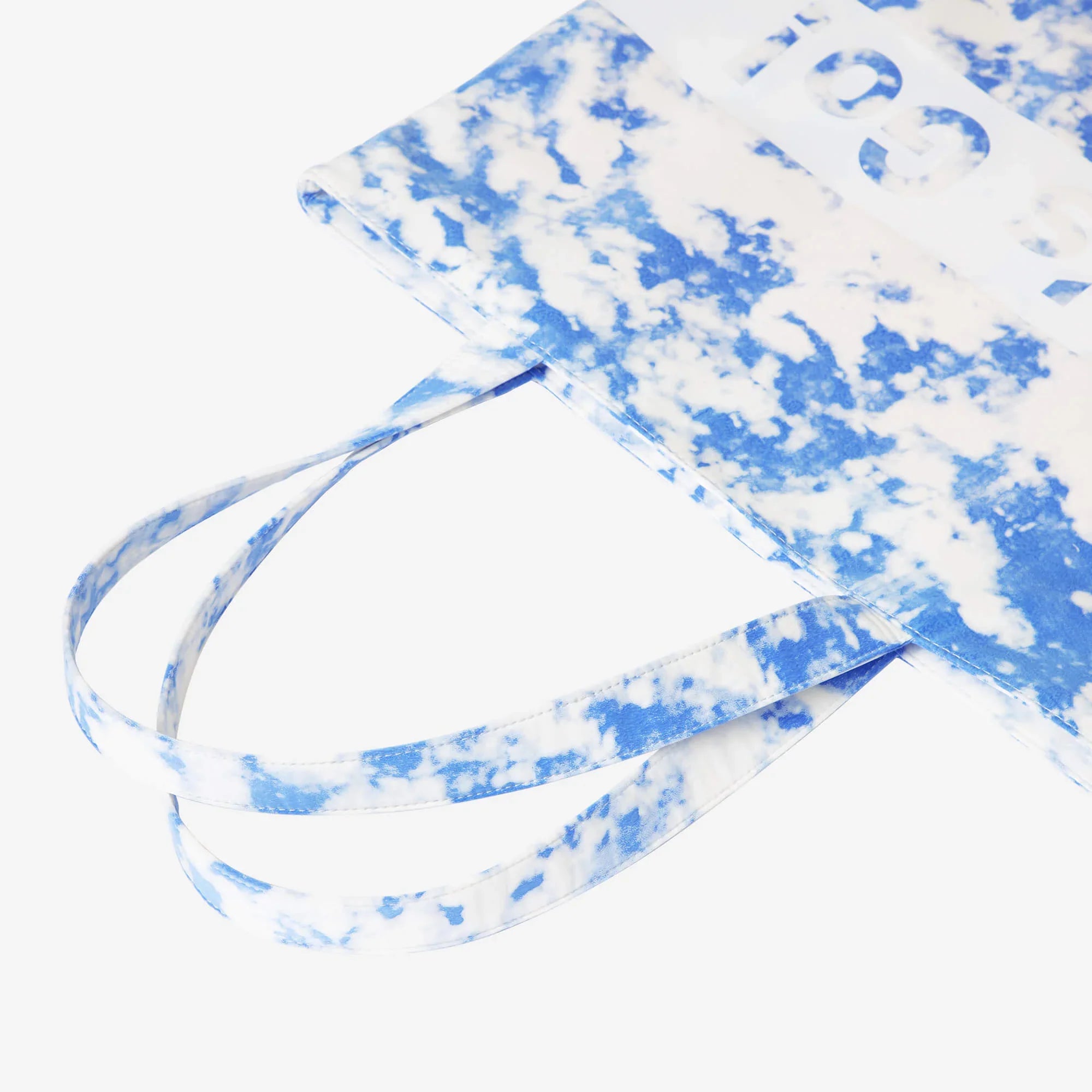 Blue and white tie-dye tote bag with bold graphic text, stylish everyday carry accessory