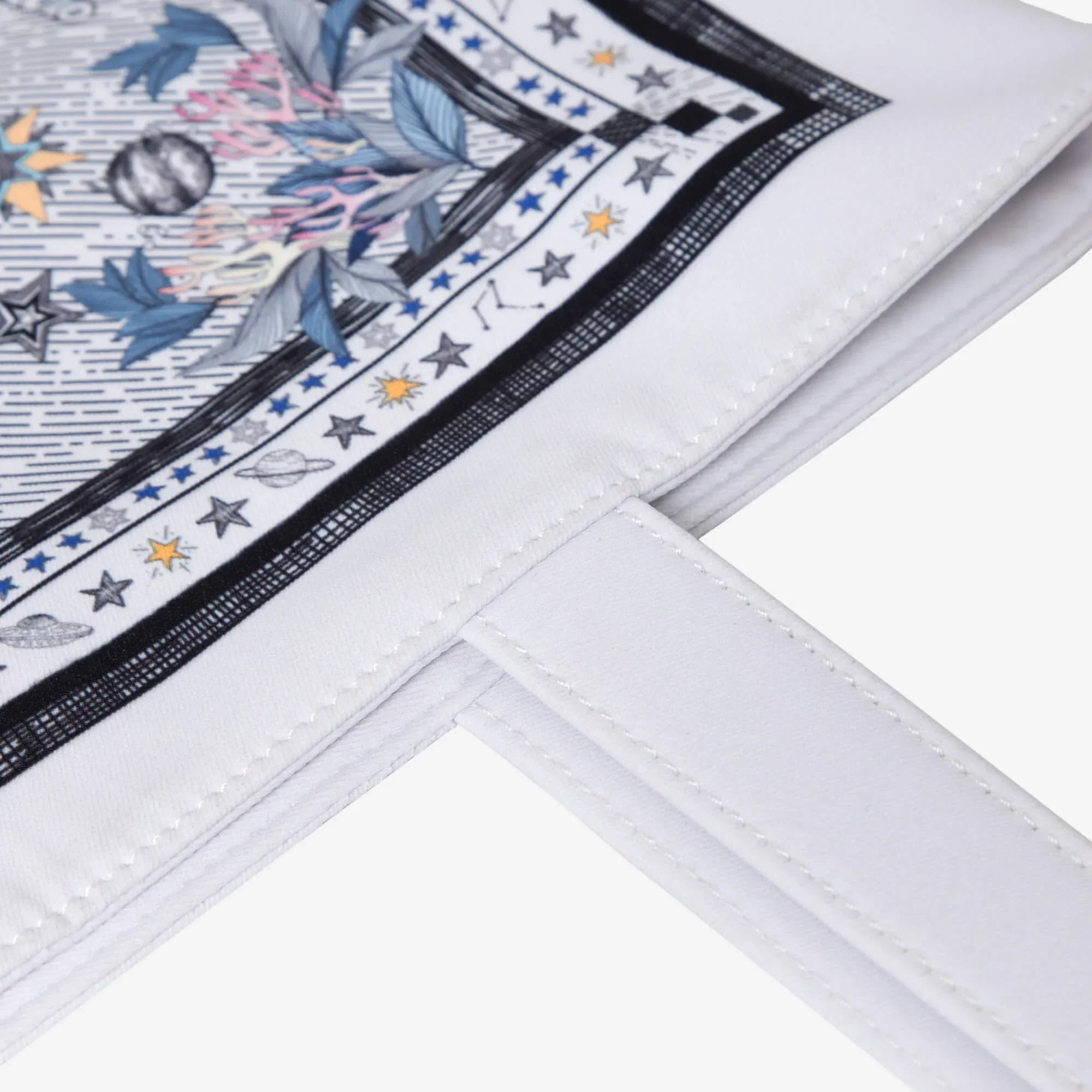 White bag with cosmic print featuring stars, planets, and leaves, ideal for stylish everyday use.