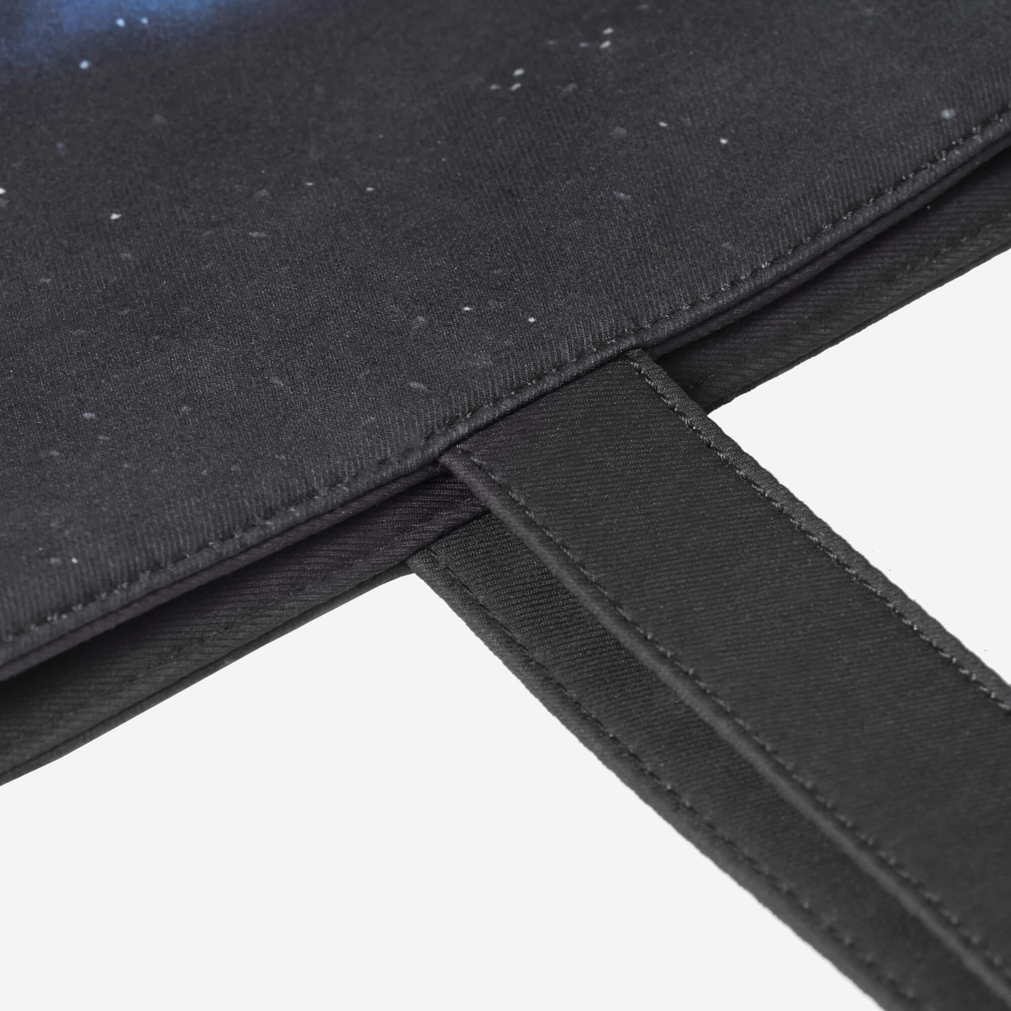 Black fabric bag with starry night print and reinforced stitching detail