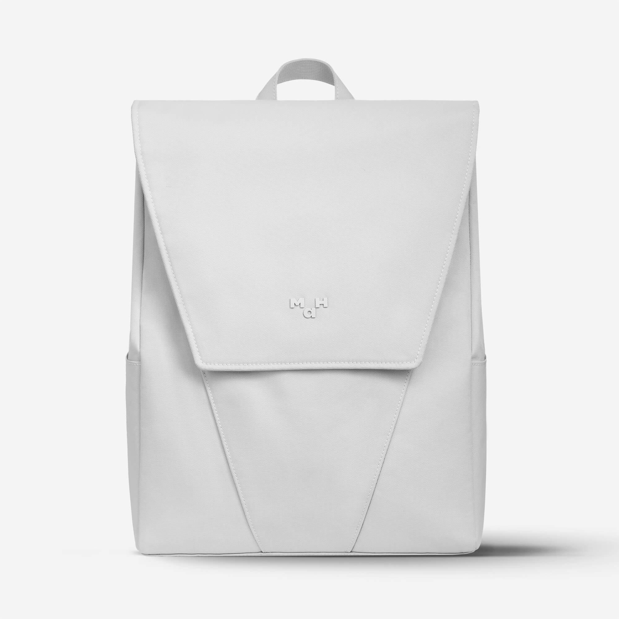 Minimalist white backpack with flap closure and subtle logo, ideal for daily use or travel