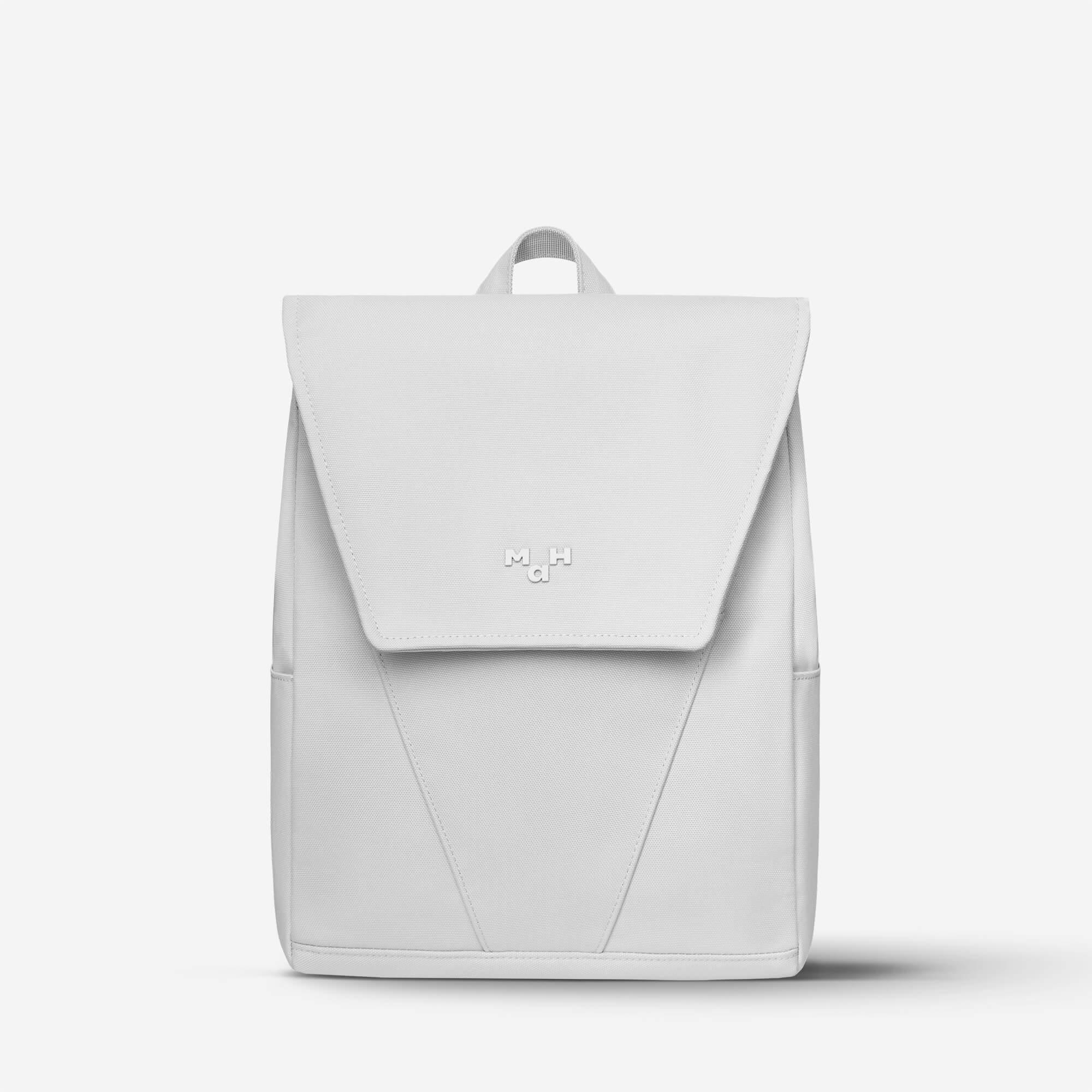 Minimalist white backpack with flap closure and subtle logo, ideal for daily use or travel.