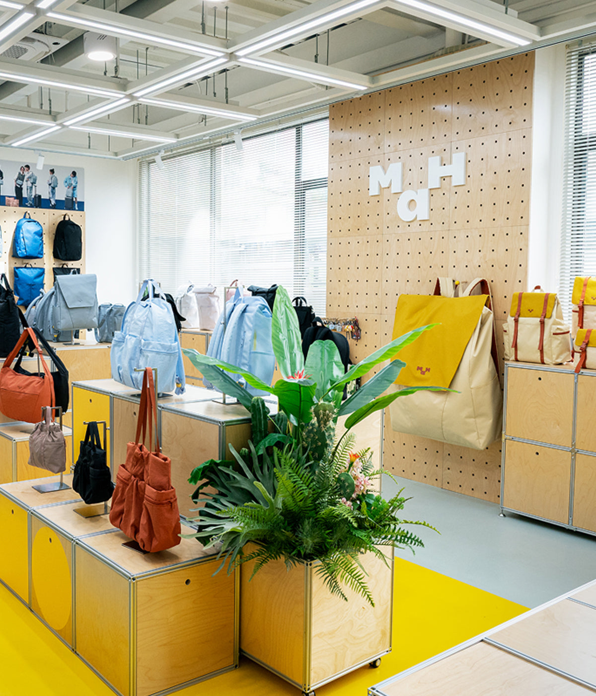 Display of colorful design-driven backpacks and bags in a modern retail store interior.
