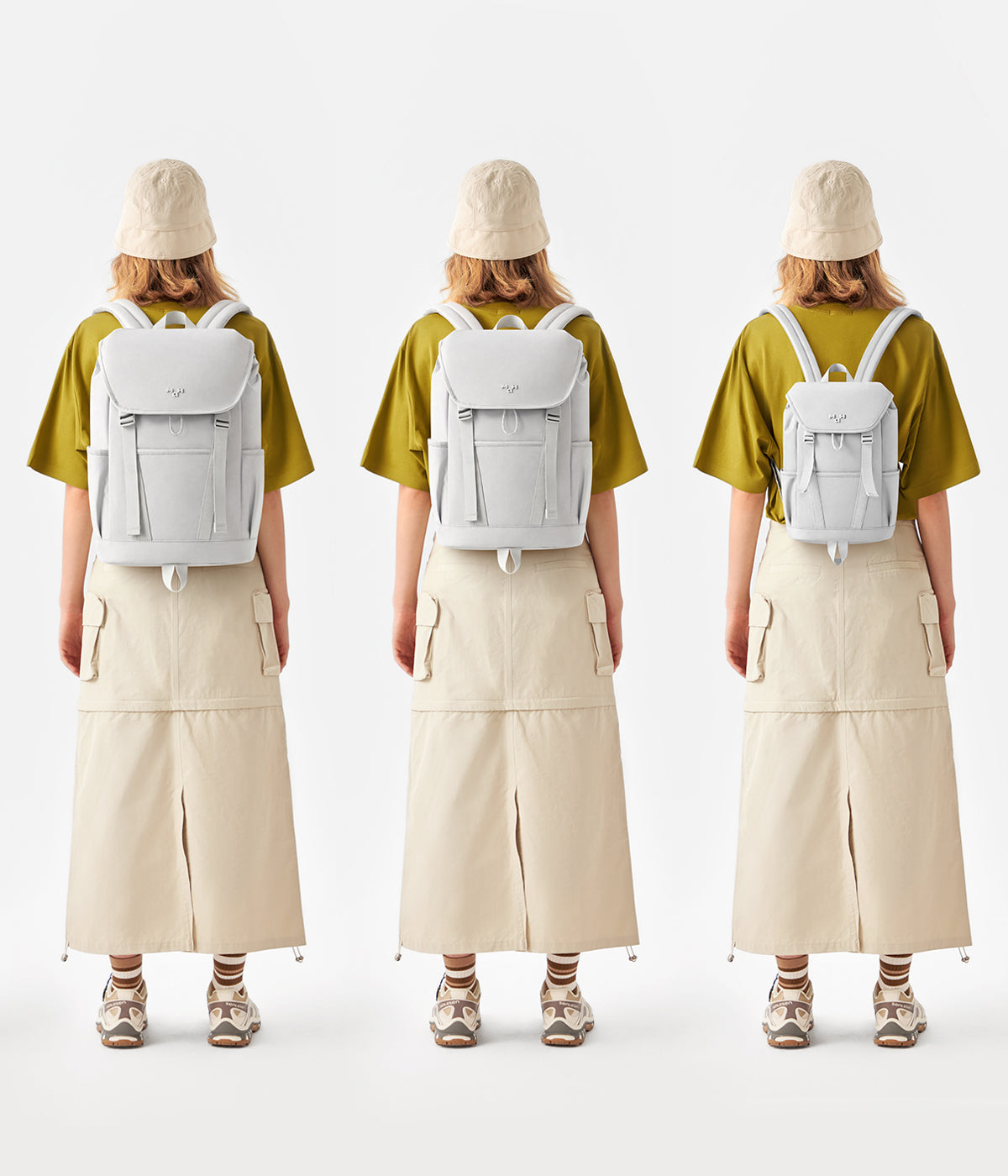 Light gray minimalist backpack worn with olive tee and beige skirt, ideal for daily carry and travel