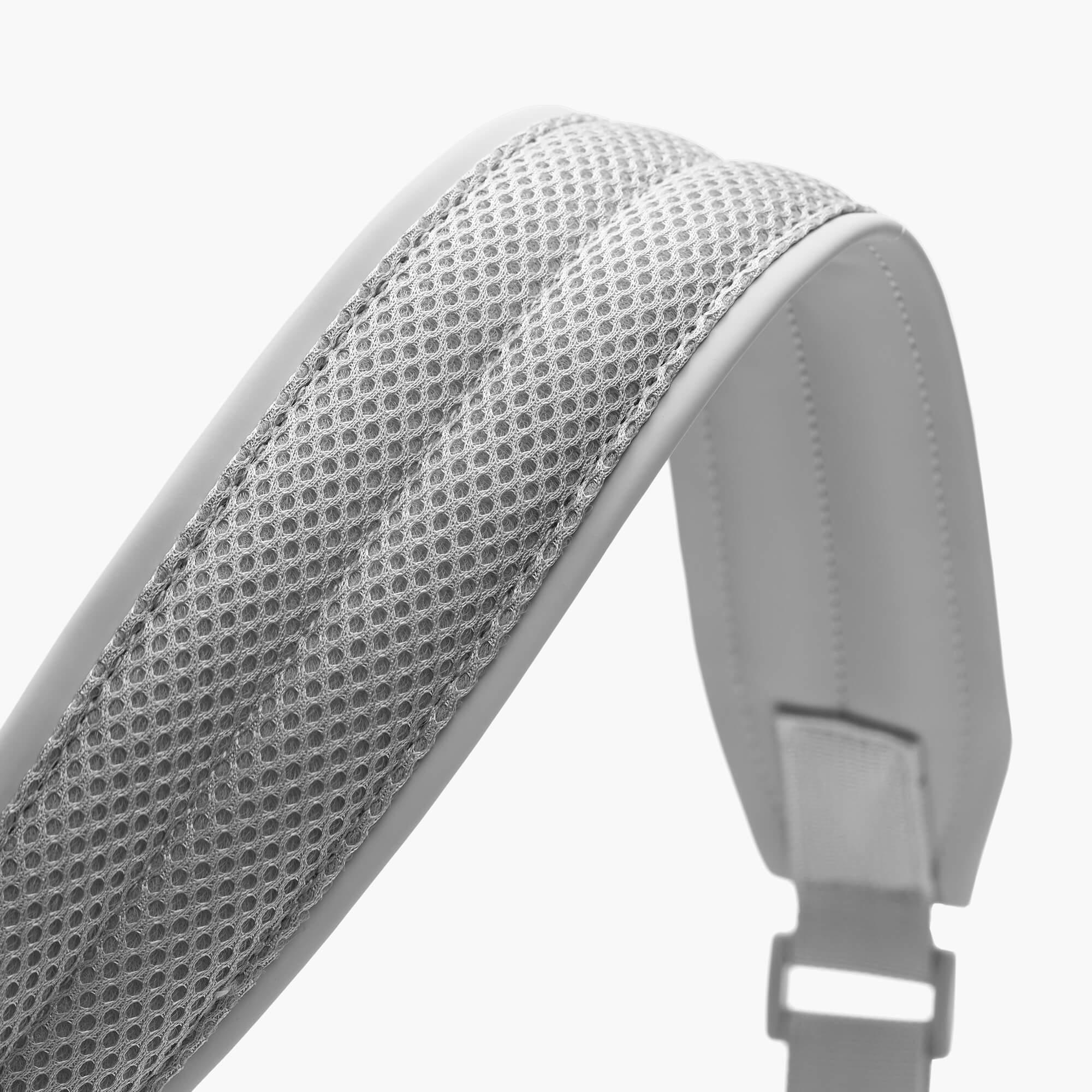 Grey backpack shoulder strap with breathable mesh padding and adjustable buckle