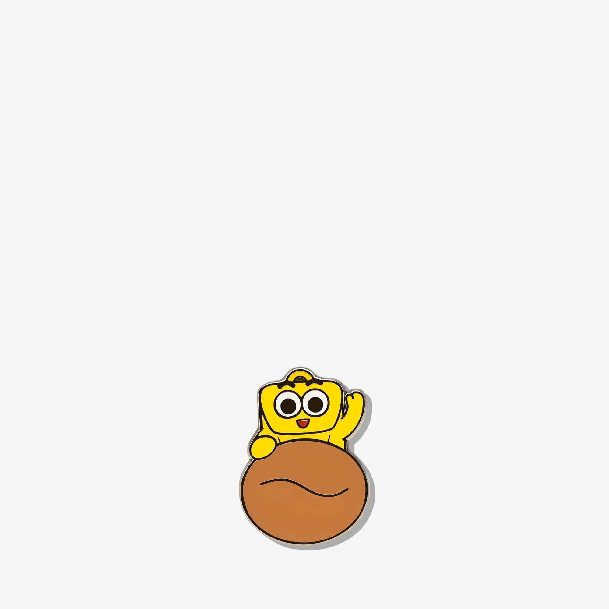 Cute yellow cartoon character pin waving from a brown bread roll, fun accessory for bags or jackets