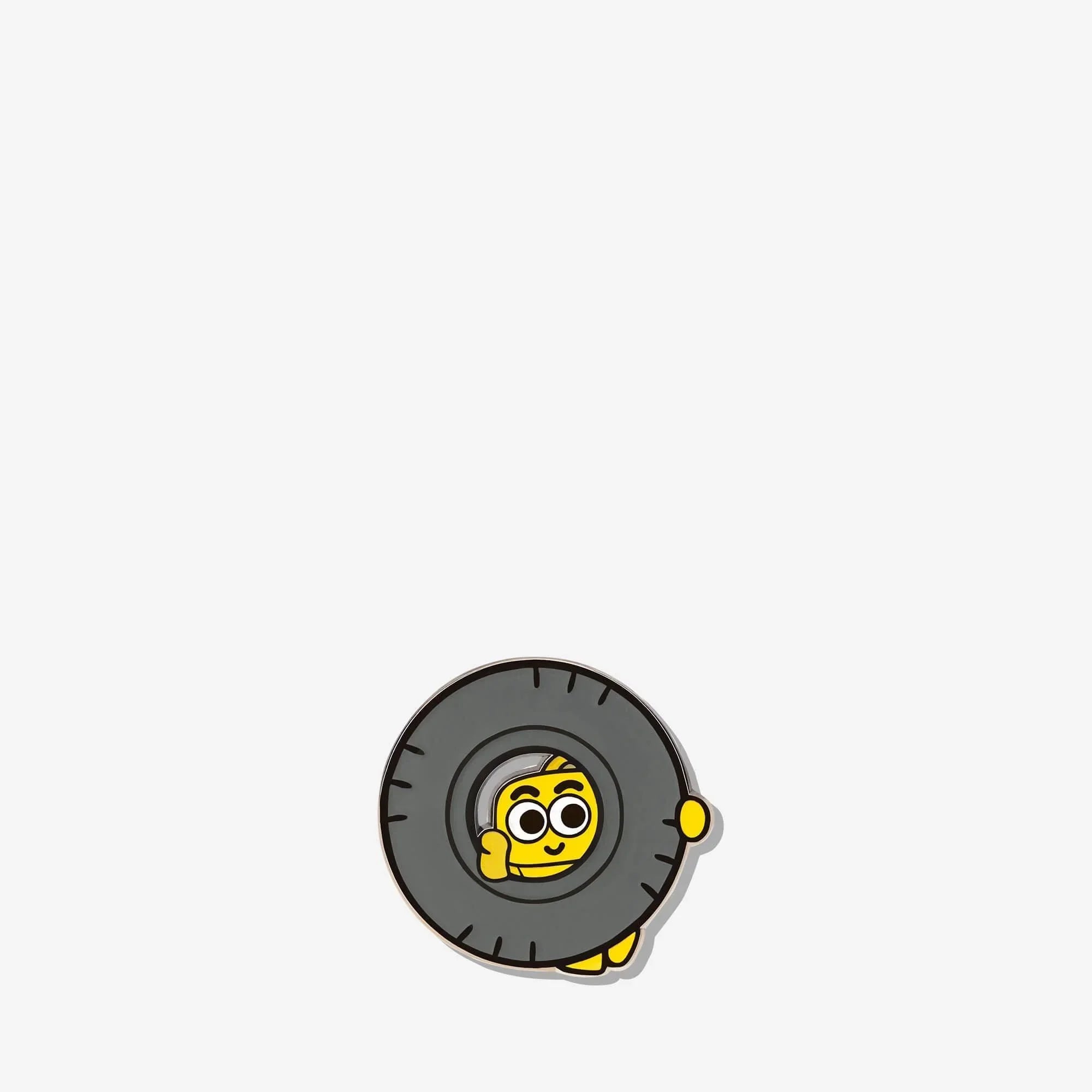 Cute yellow character enamel pin with tire design, fun accessory for bags or jackets