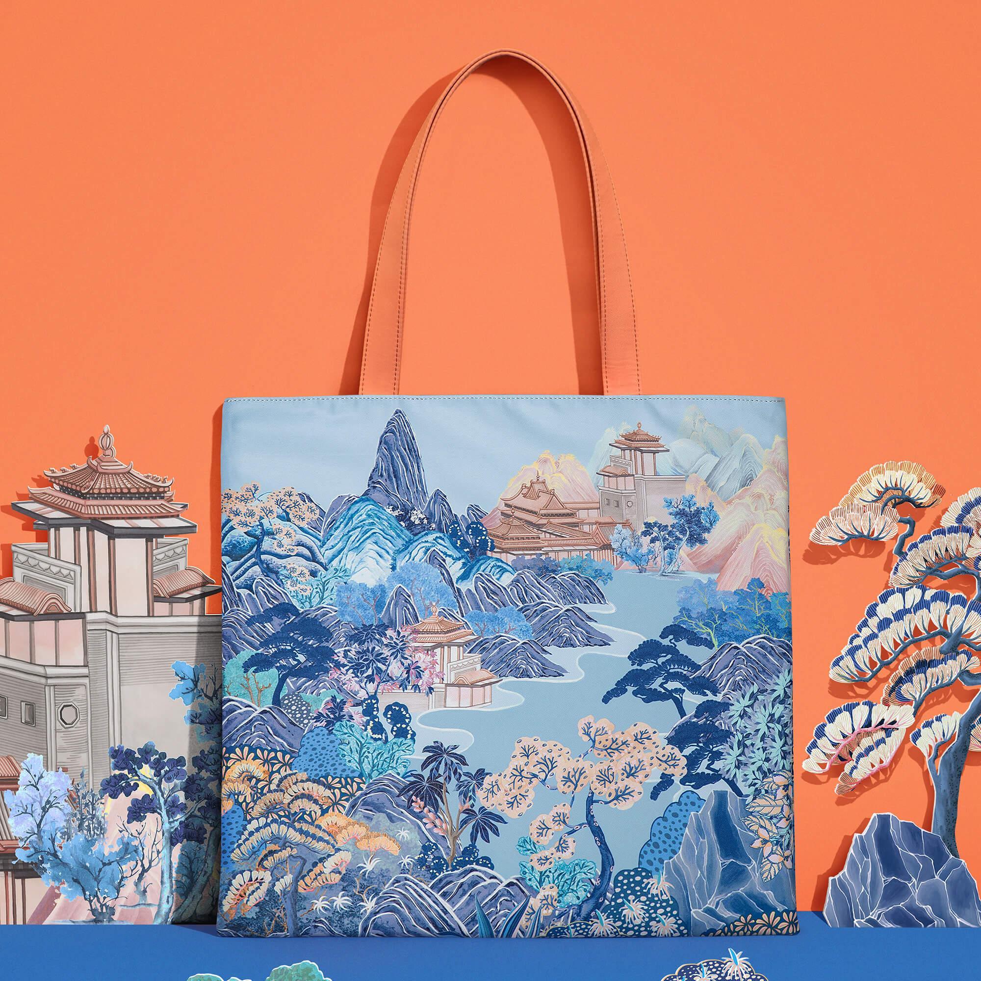 Stylish tote bag with blue mountain landscape print, perfect for everyday carry and travel