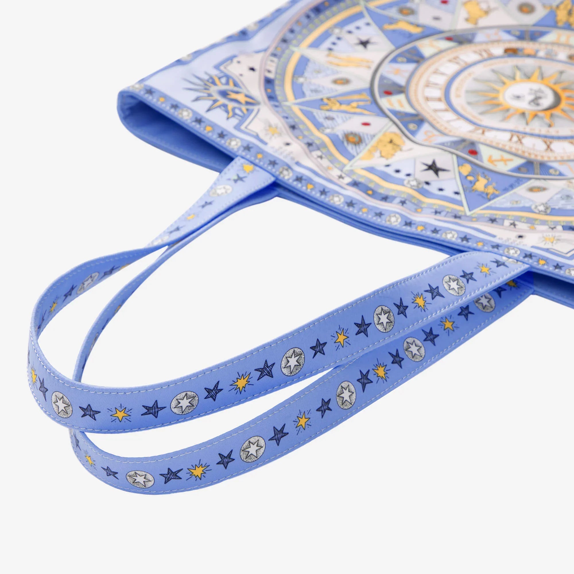 Blue tote bag with celestial star and sun pattern, ideal for everyday use or as a stylish accessory.