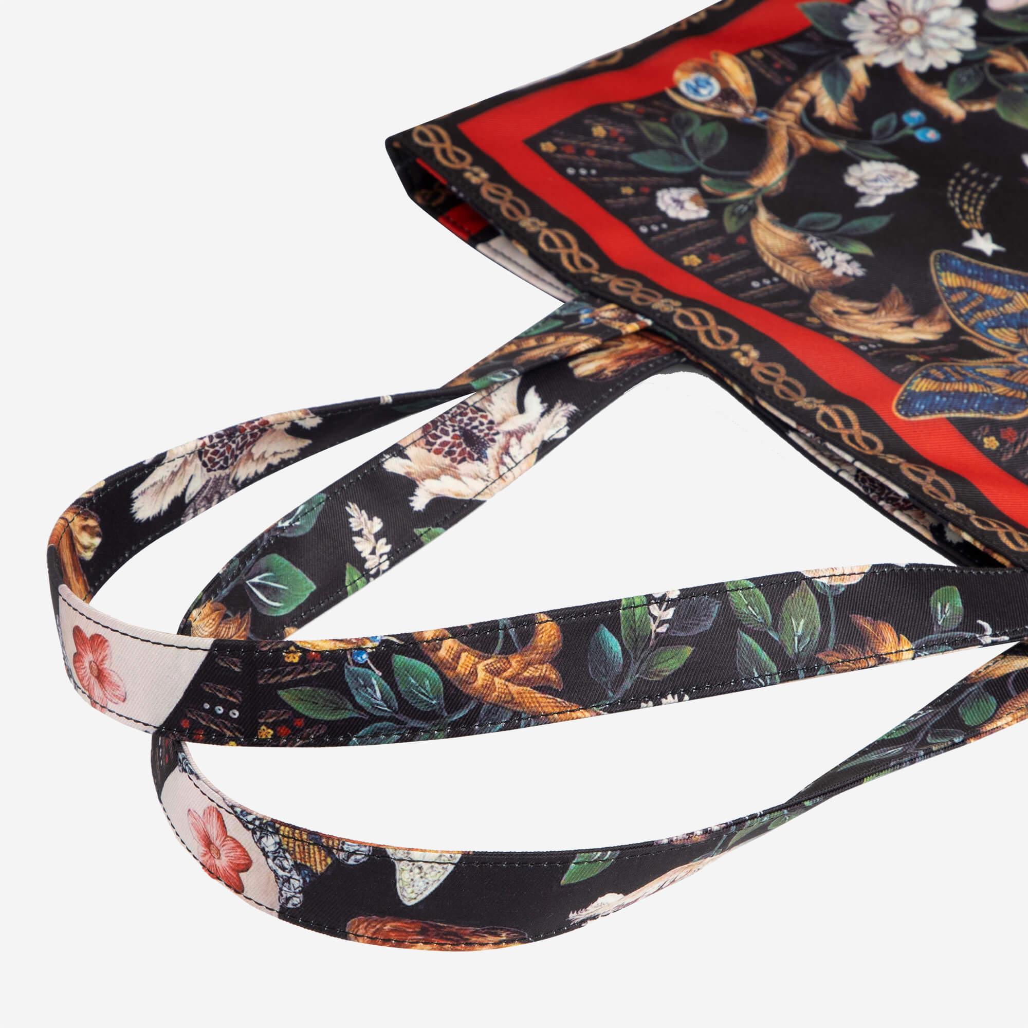 Floral and fauna print tote bag with red trim and detailed straps, stylish everyday accessory