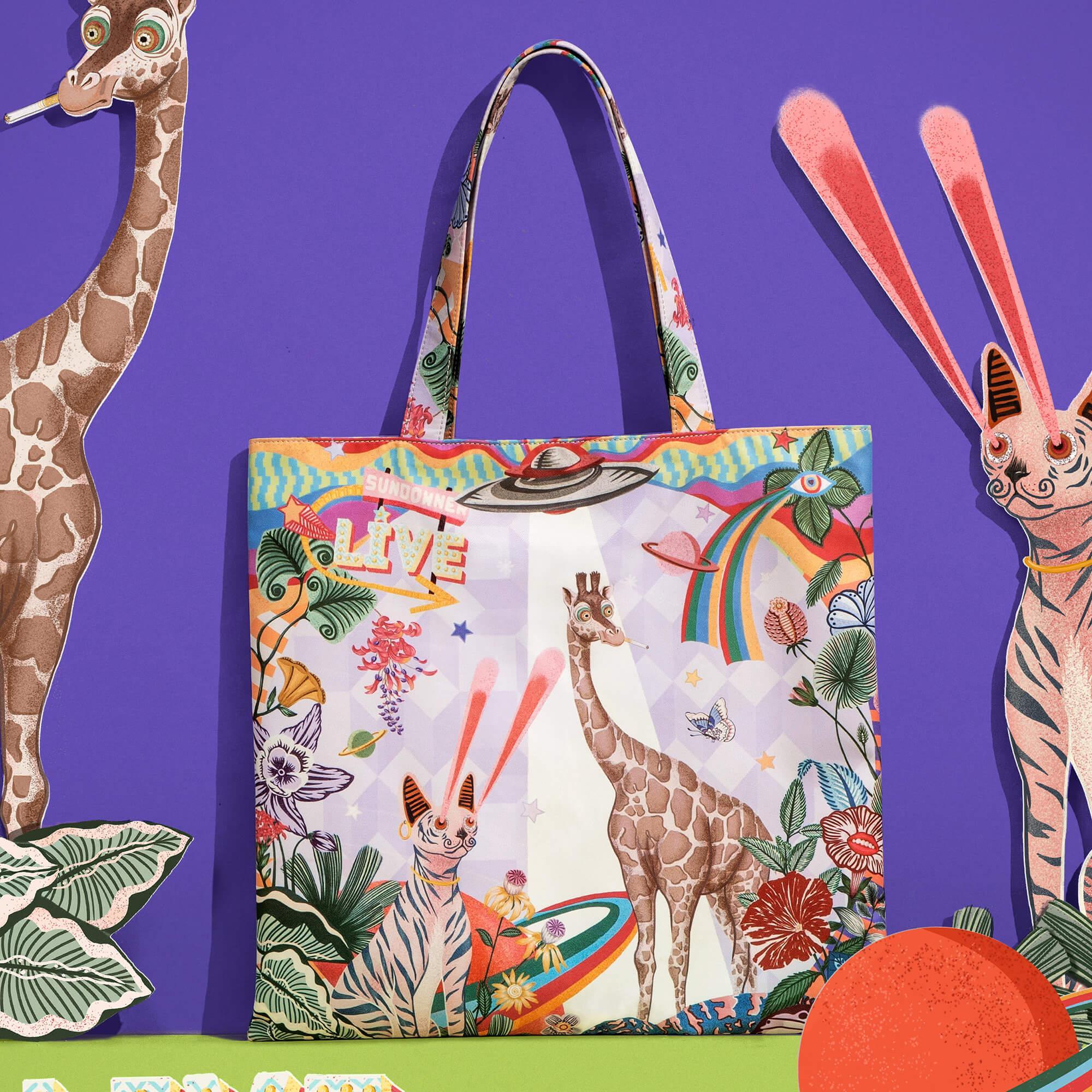 Colorful tote bag with giraffe, rabbit, rainbow, and floral print on purple background
