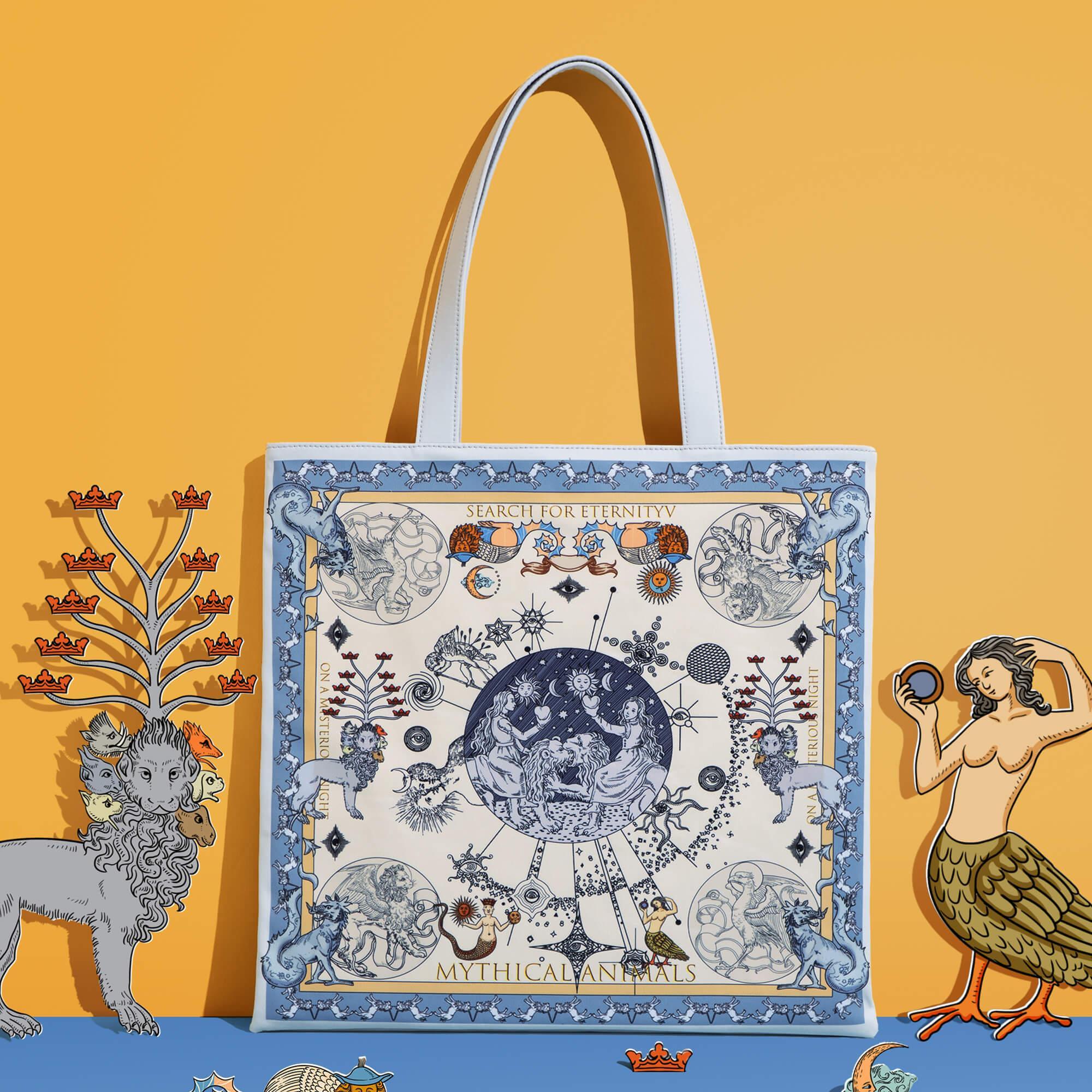 Mythical animals tote bag with celestial design, white handles, and fantasy art on vibrant yellow background