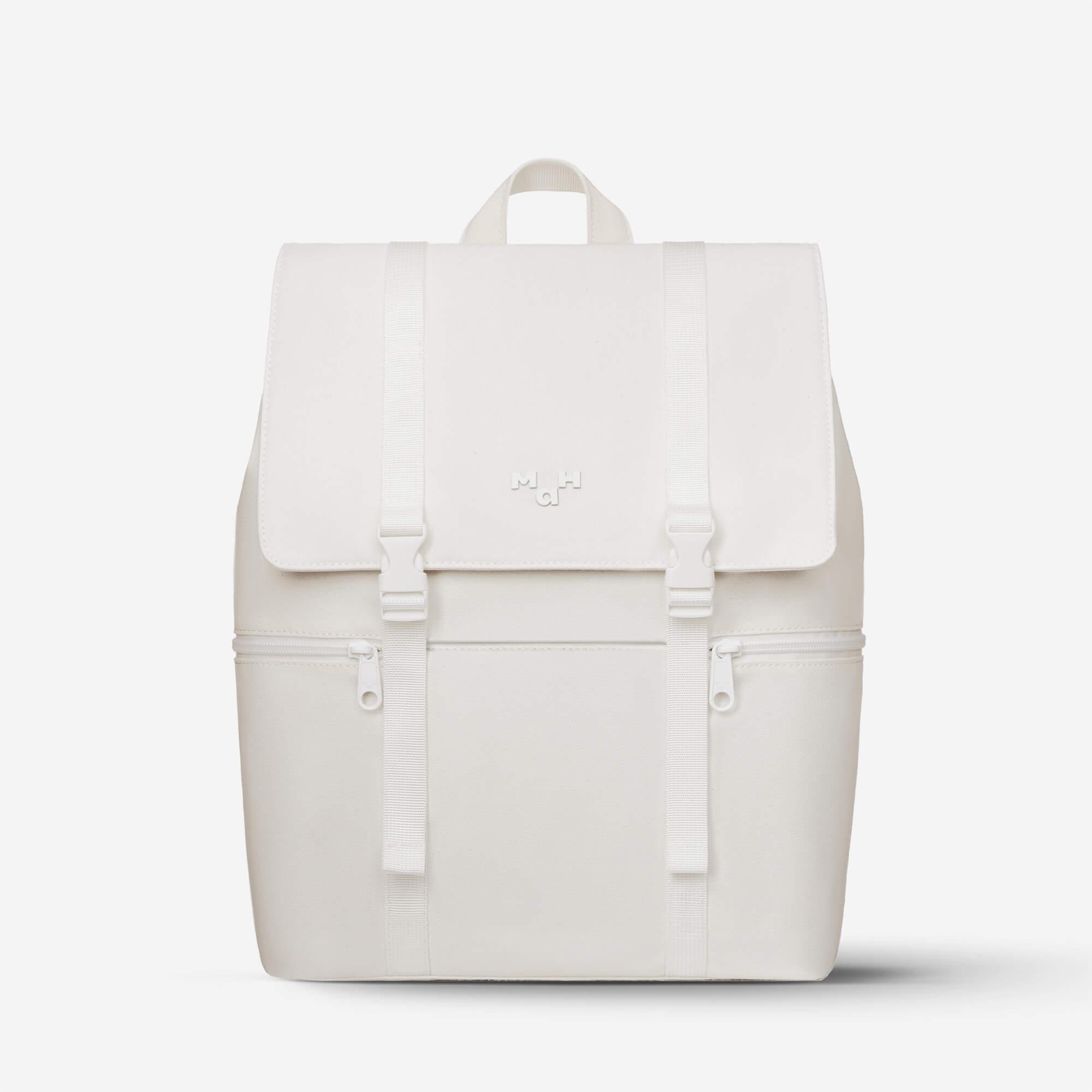 Minimalist white canvas backpack with front flap, straps, and dual zippers for everyday use