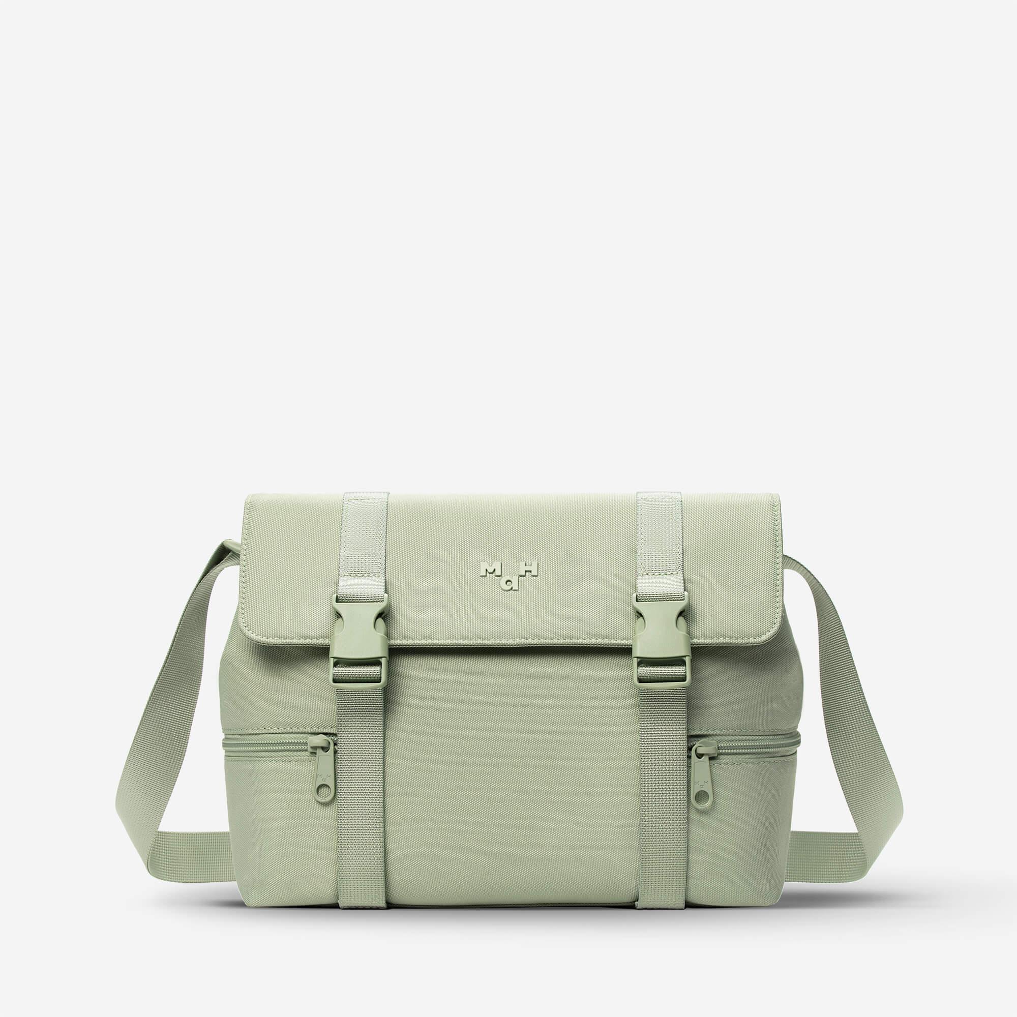 Mint green satchel bag with adjustable straps and front pockets, ideal for daily use or travel.