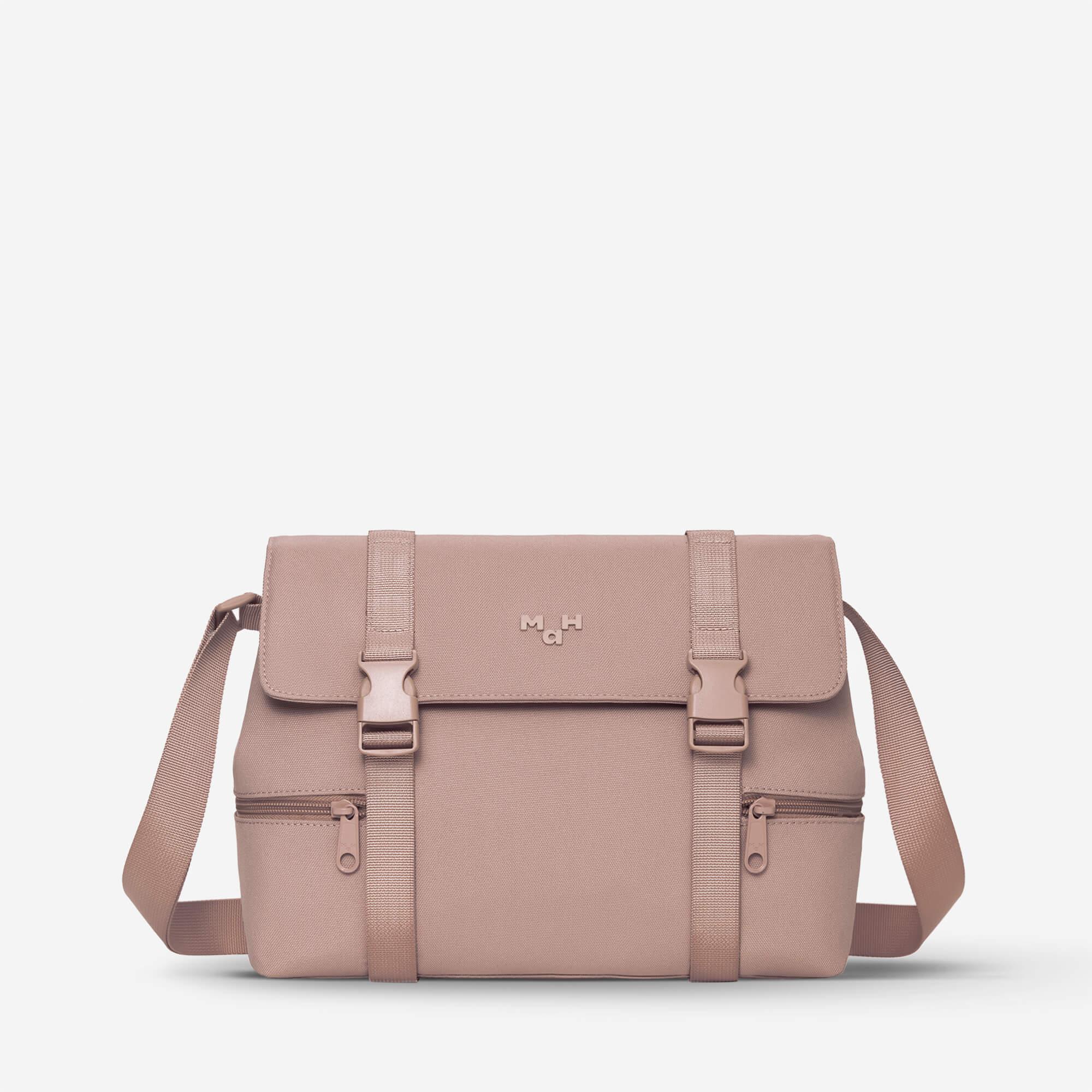 Dusty rose satchel bag with front buckles and adjustable strap, ideal for everyday carry and travel