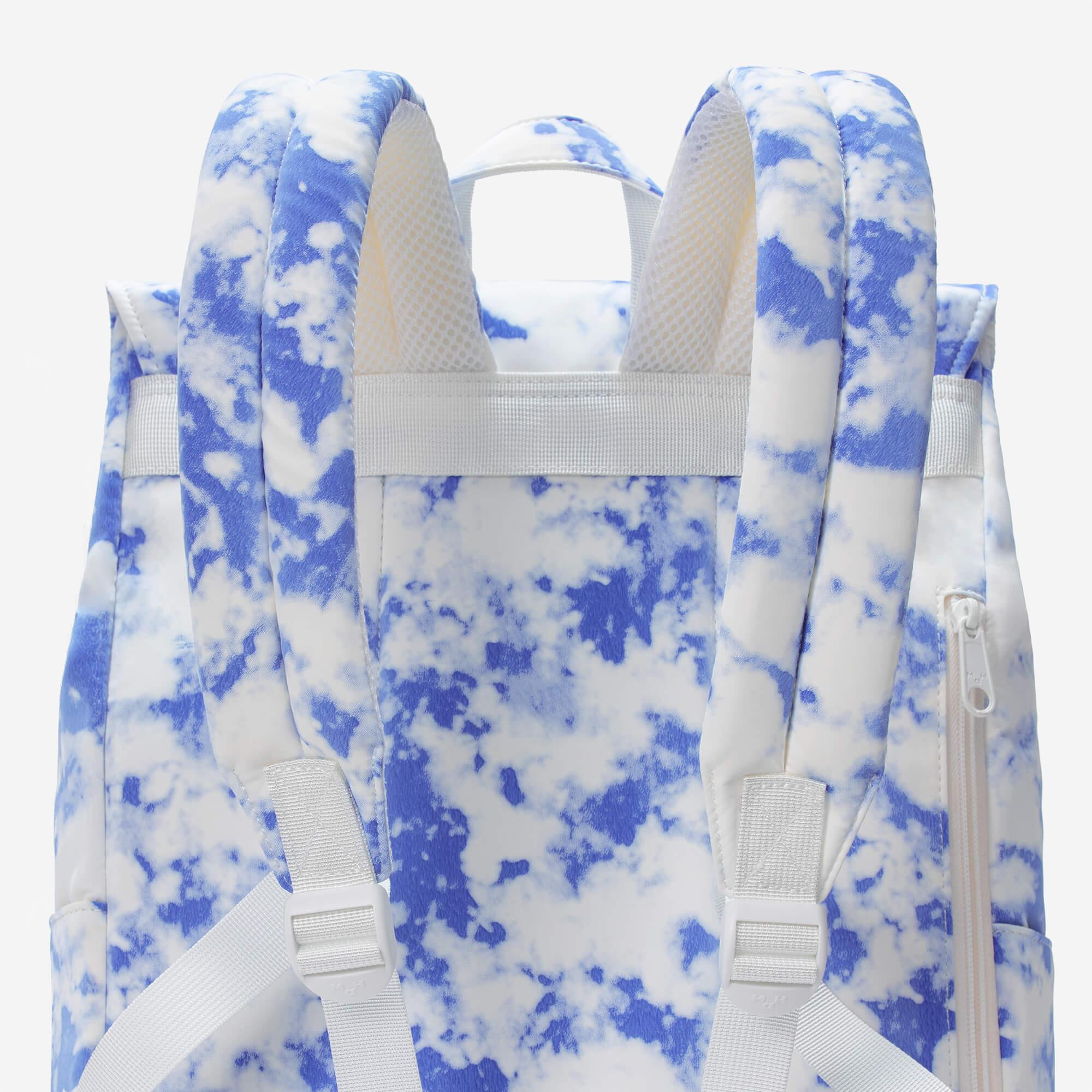 Blue and white cloud print backpack with padded straps and mesh back panel