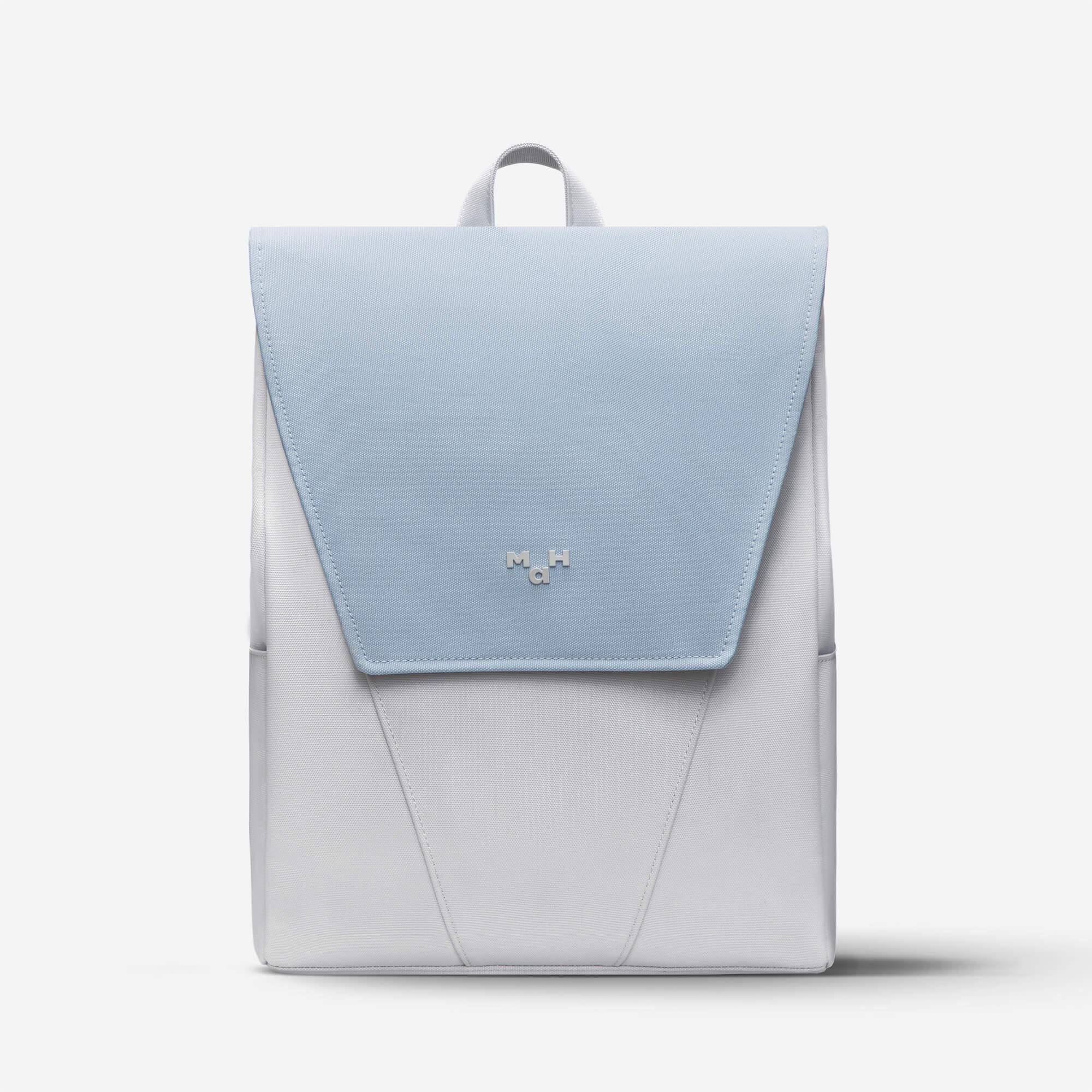 Light blue and white minimalist backpack with front flap and subtle logo, ideal for daily use or travel.