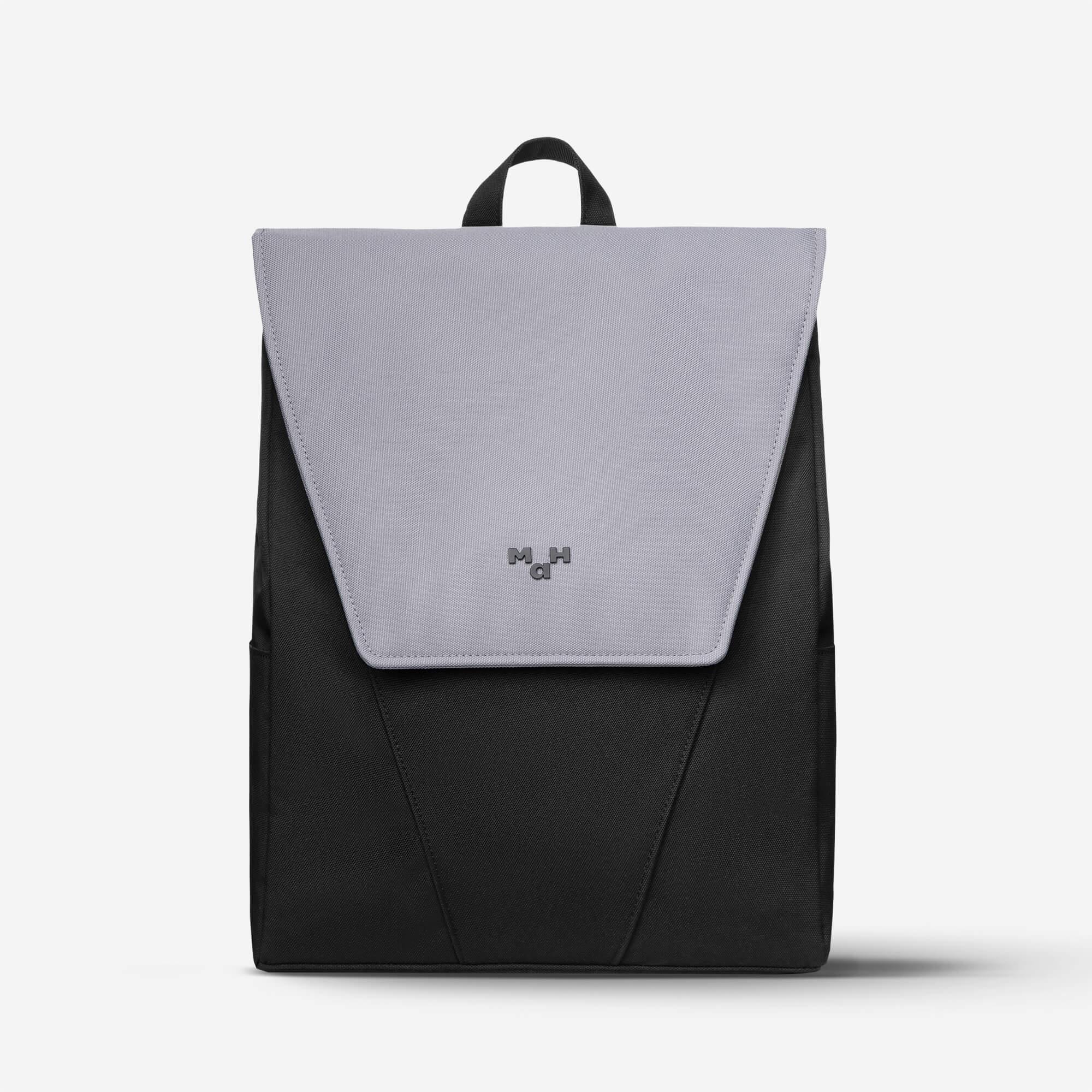 Modern black and gray backpack with flap closure and top handle, ideal for everyday use and travel.