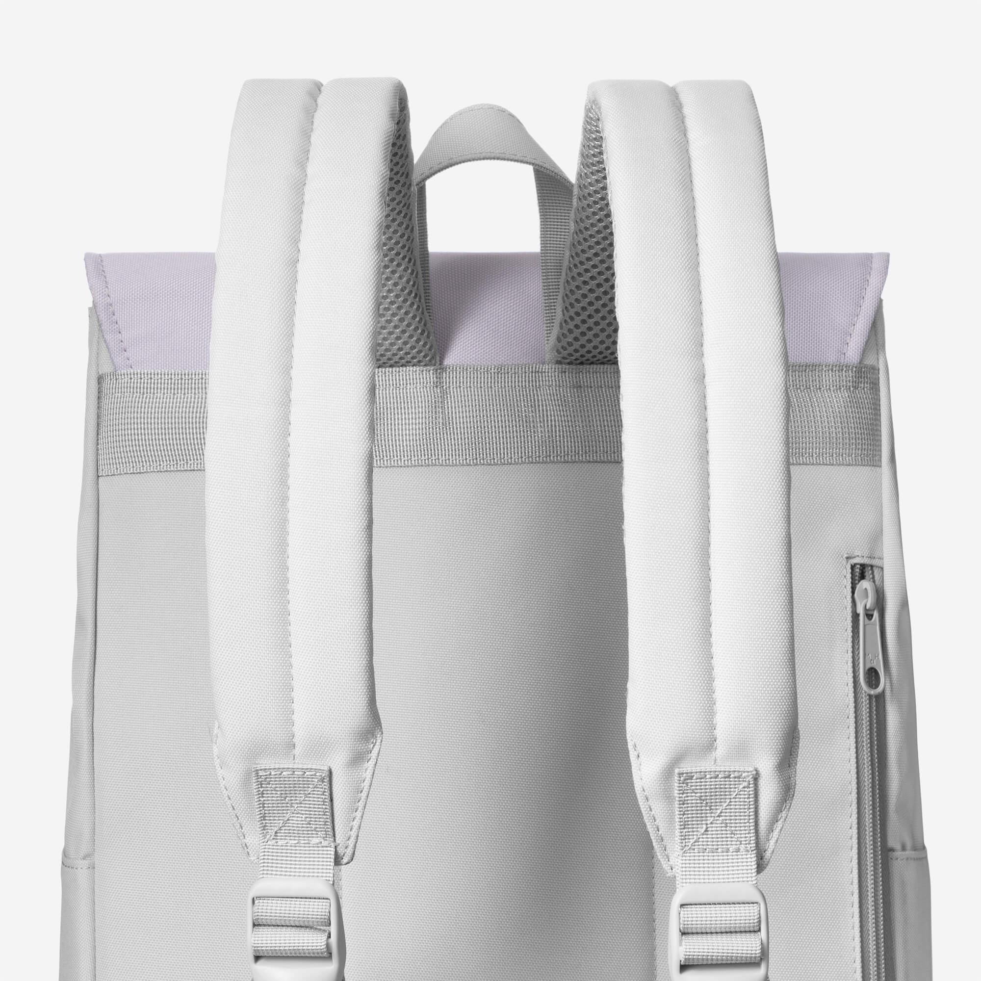 Light gray backpack with padded straps, mesh back panel, and side zipper pocket for everyday use