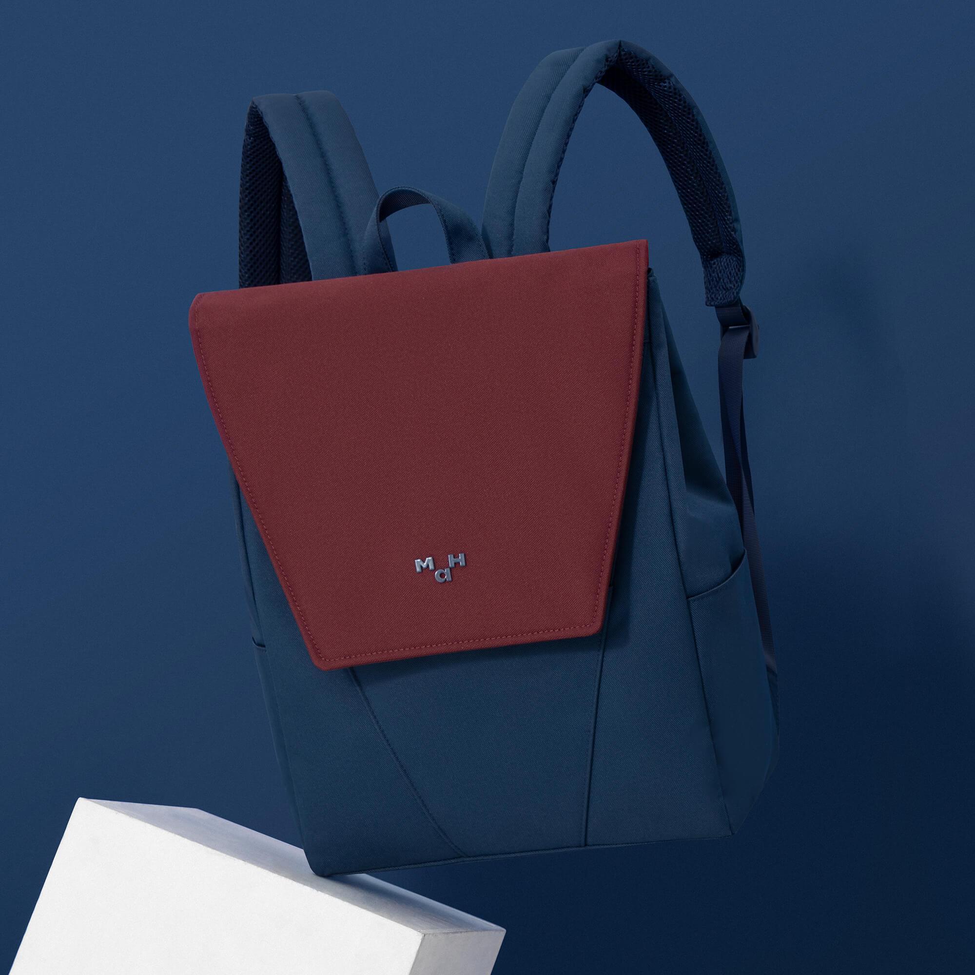 Modern navy blue and burgundy backpack with minimalist design, ideal for daily use or travel