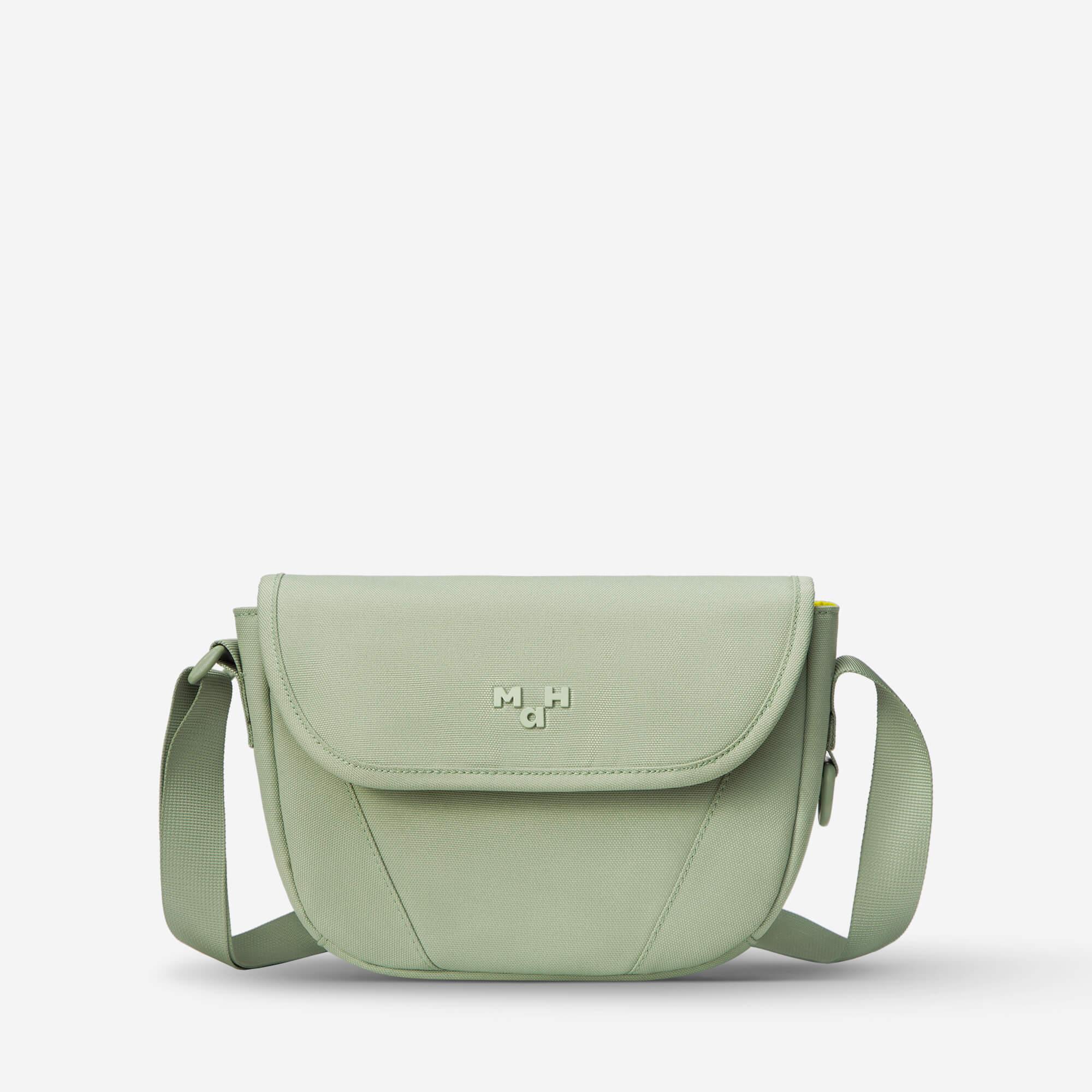 Mint green crossbody bag with flap closure and adjustable strap, ideal for everyday use and travel.