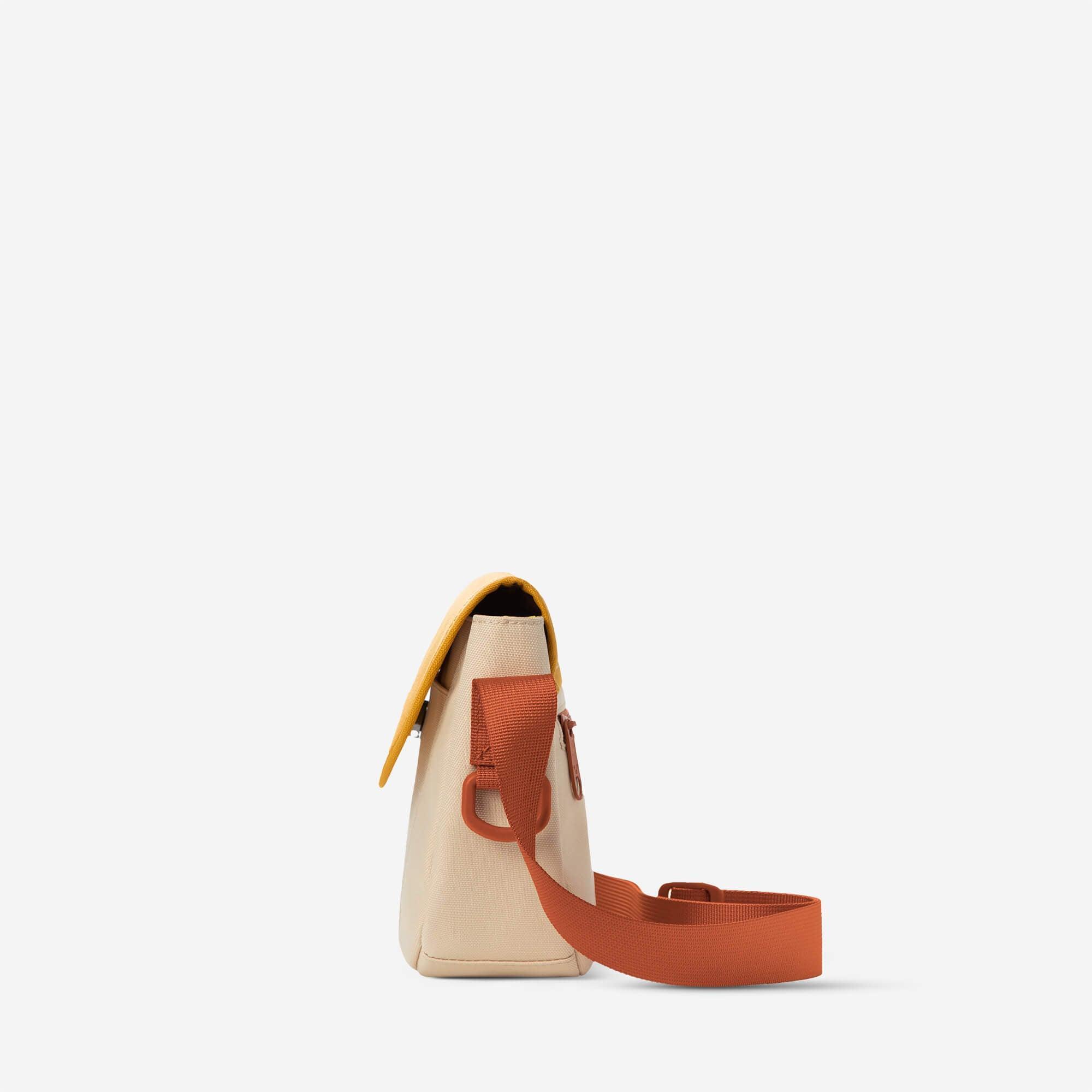 Beige crossbody bag with orange strap and yellow flap, minimalist design for everyday use