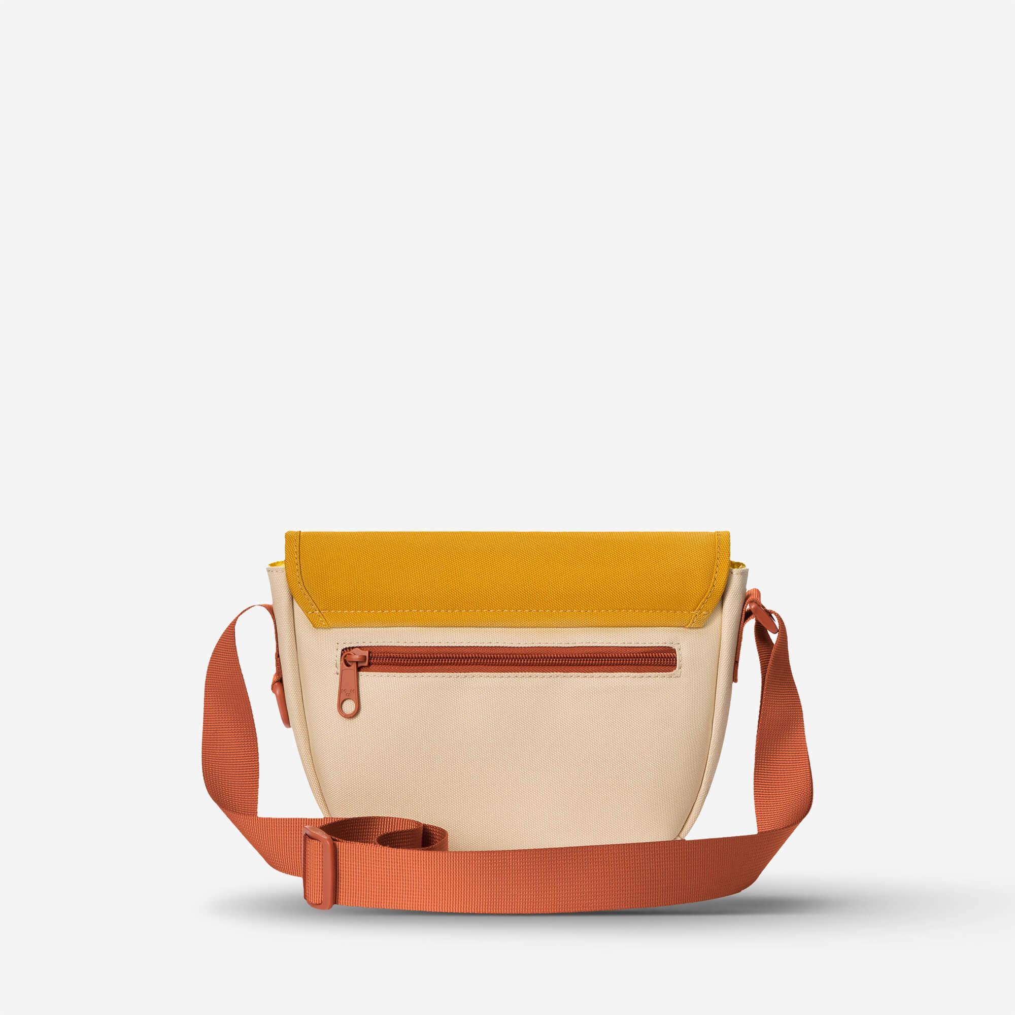 Mustard and cream crossbody bag with orange strap and front zipper pocket