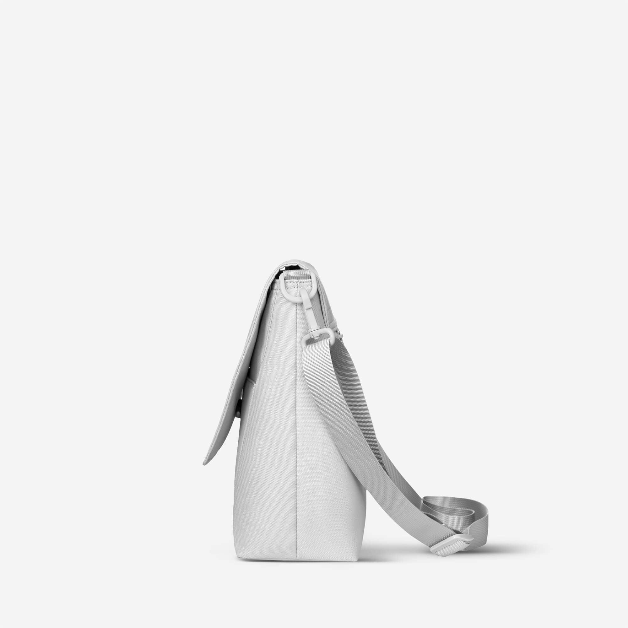 Minimalist white crossbody bag with adjustable strap and clean design